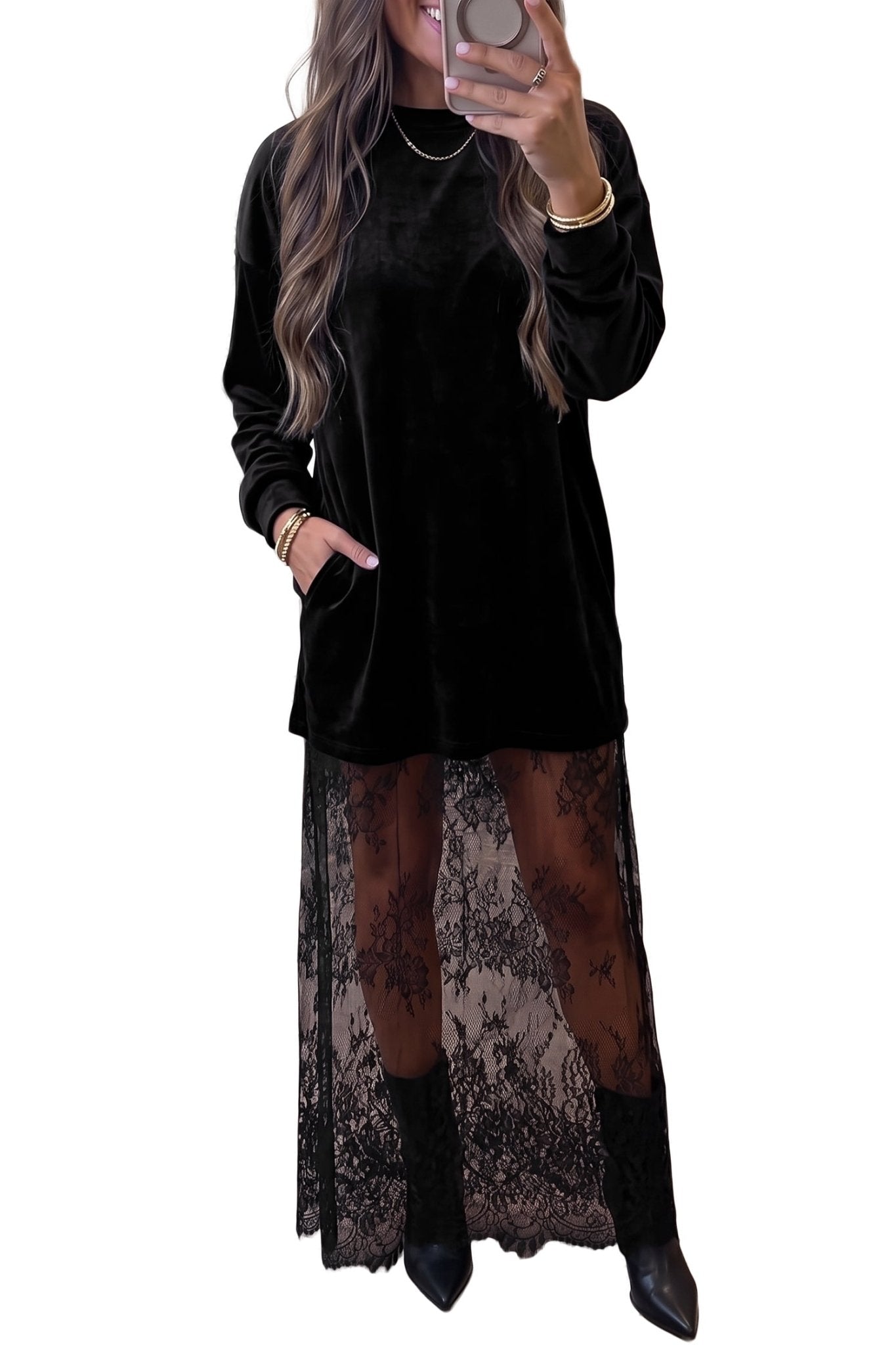 Person in black velvet tunic with sheer floral lace skirt and pointed boots.