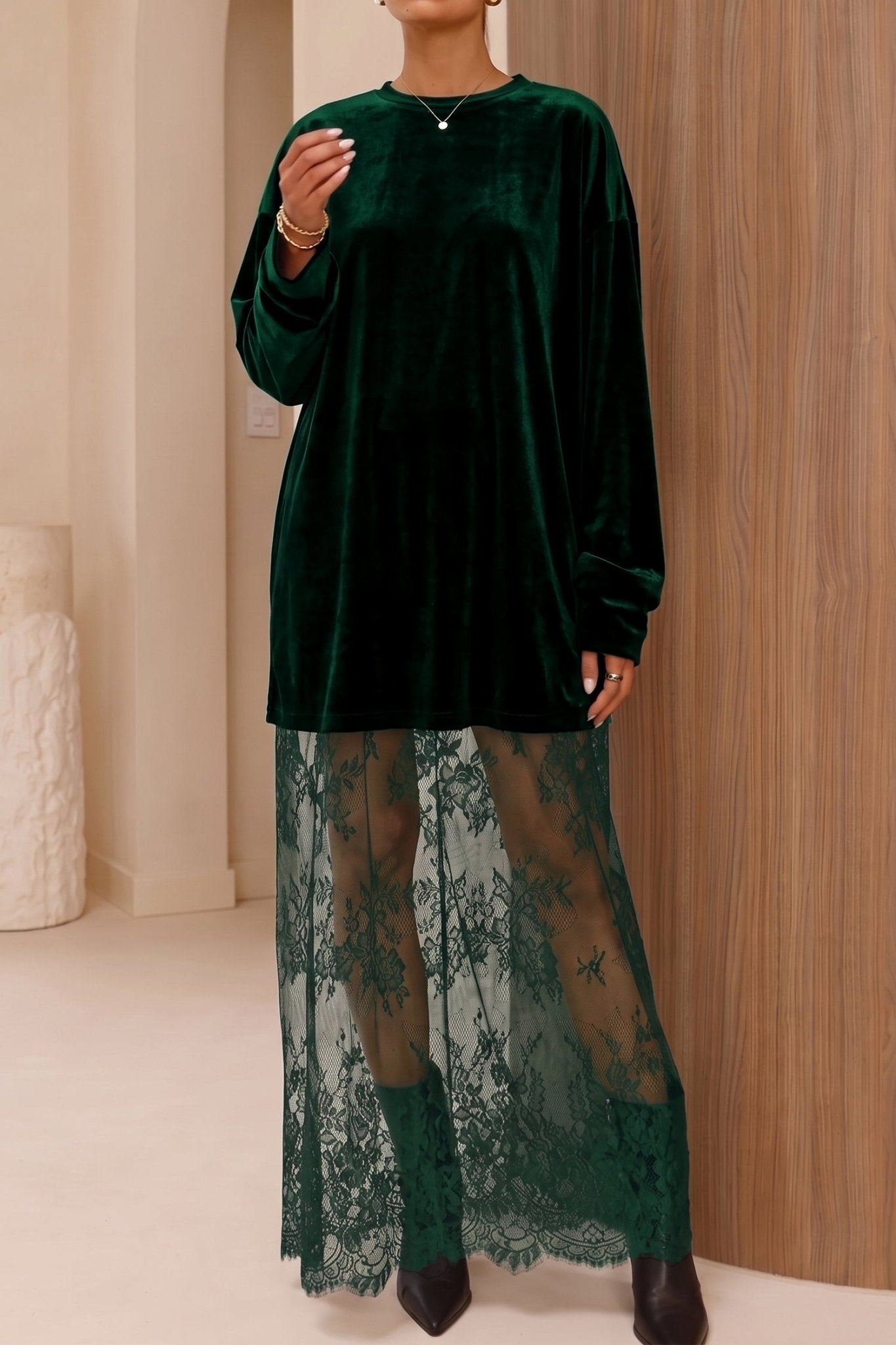 Model in dark green velvet tunic with matching sheer lace maxi skirt.
