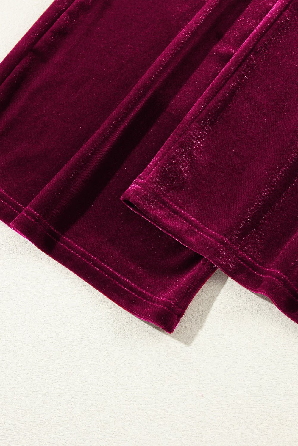 Close-up of burgundy velvet fabric on a white background