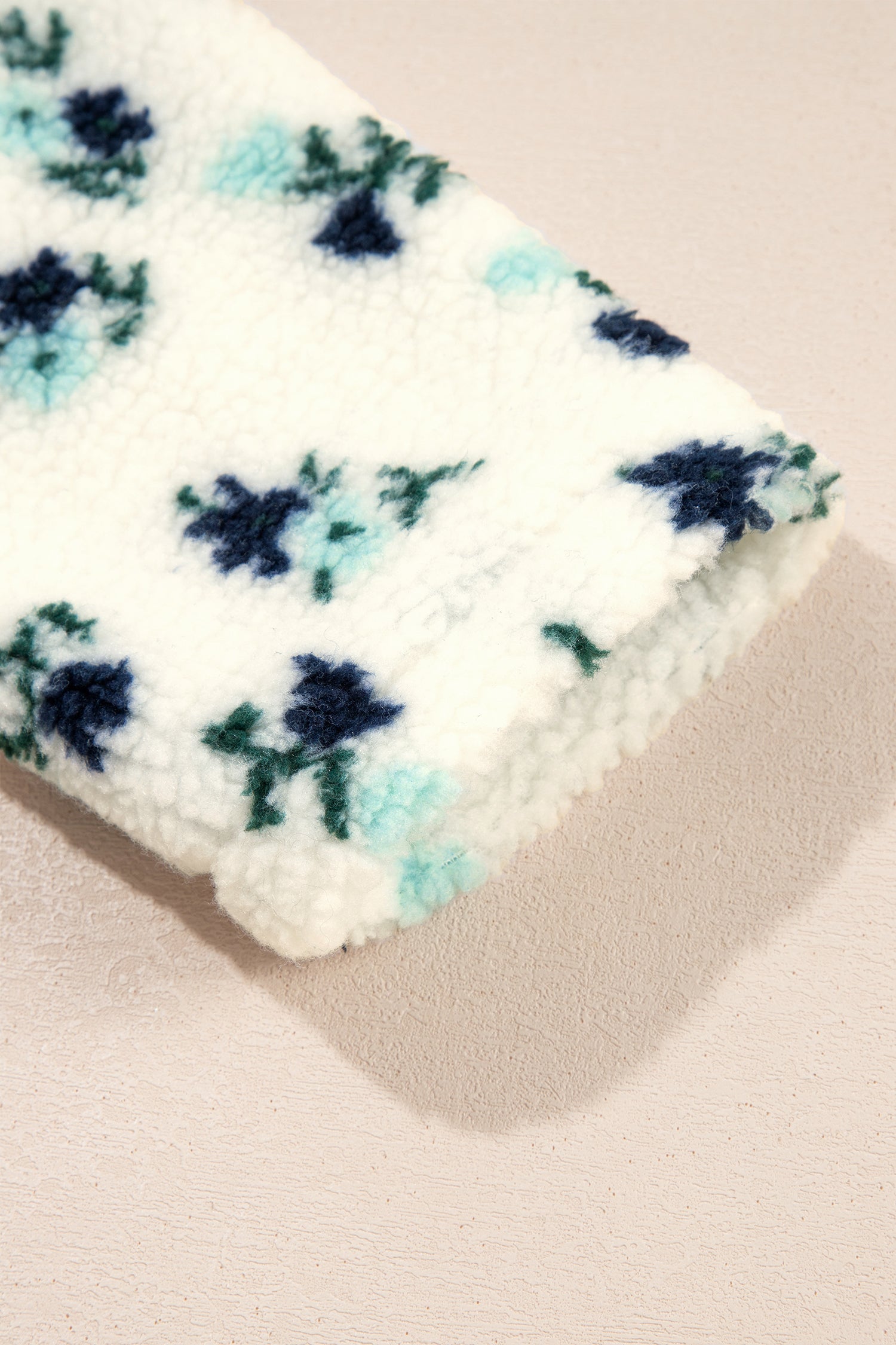 Sherpa sleeve cuff detail on white floral hooded jacket