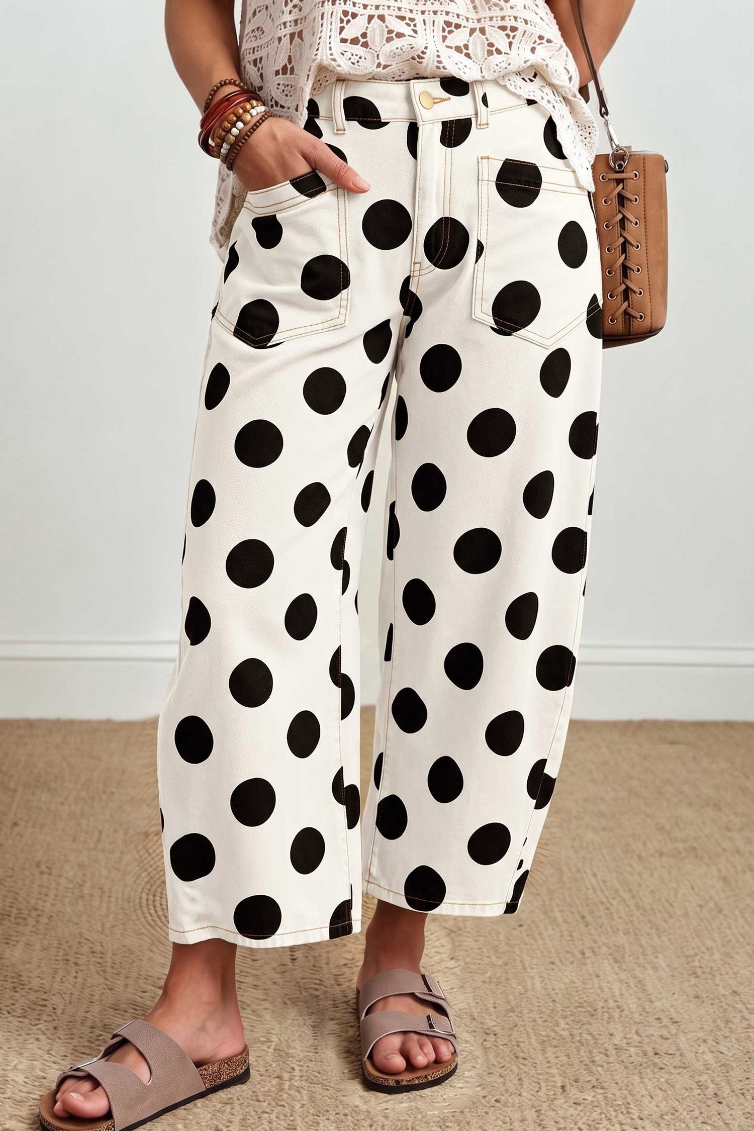 White barrel leg ankle jeans with black polka dots and patch pockets, front view