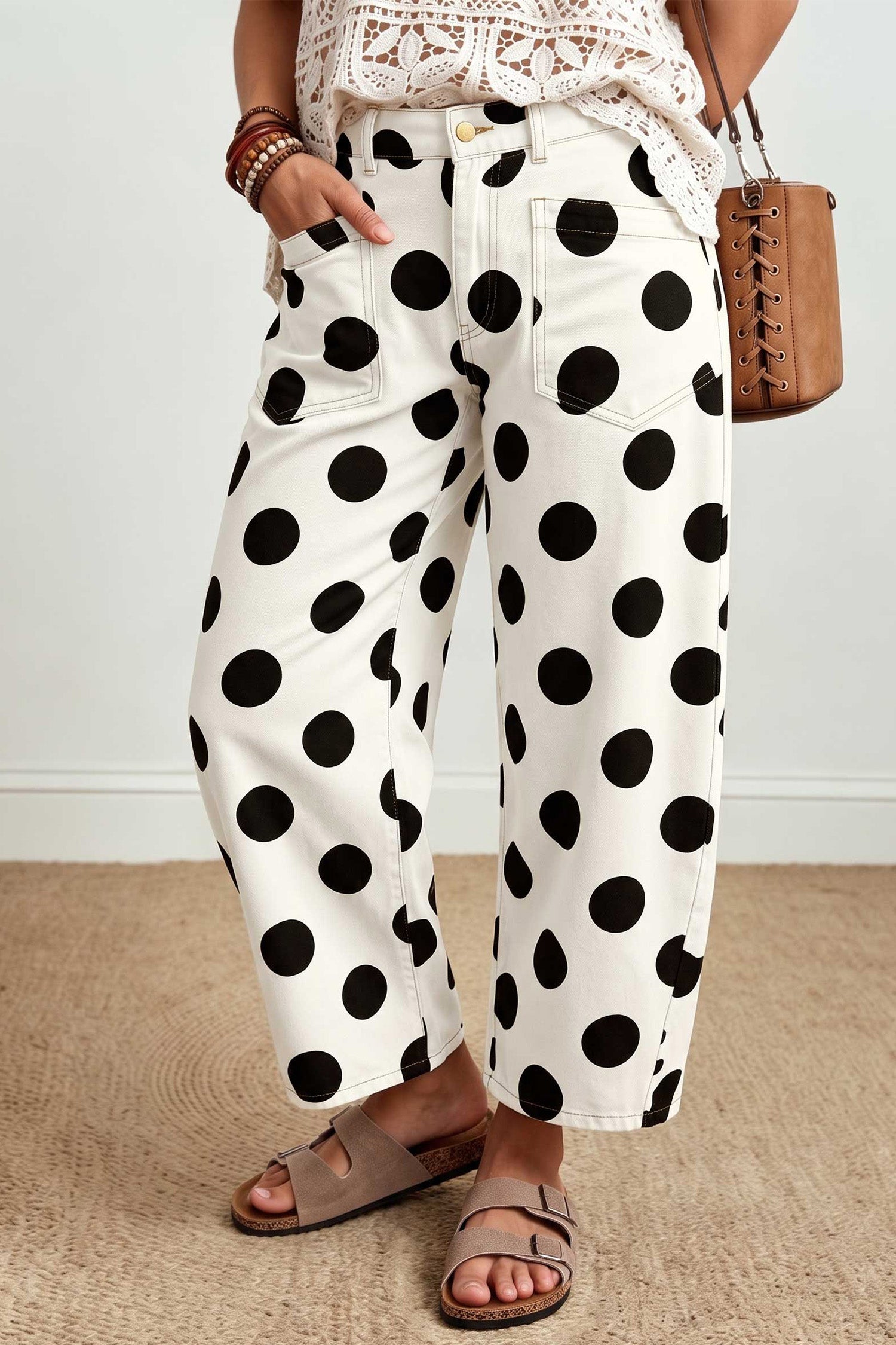 Side view of white barrel leg jeans with large black polka dots
