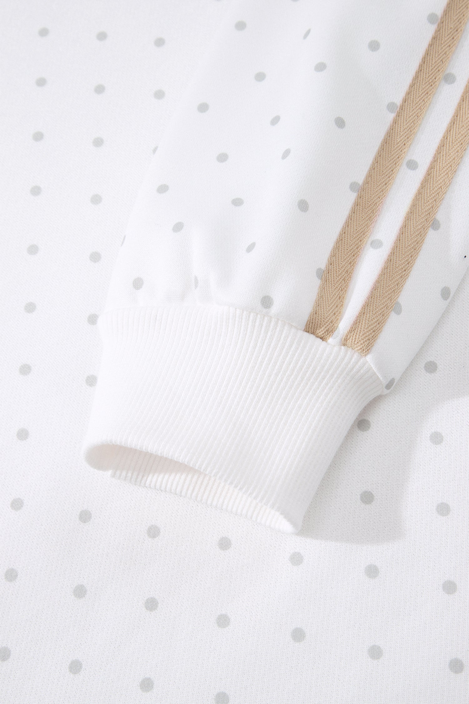 Ribbed cuff and beige side stripe on white polka dot sleeve