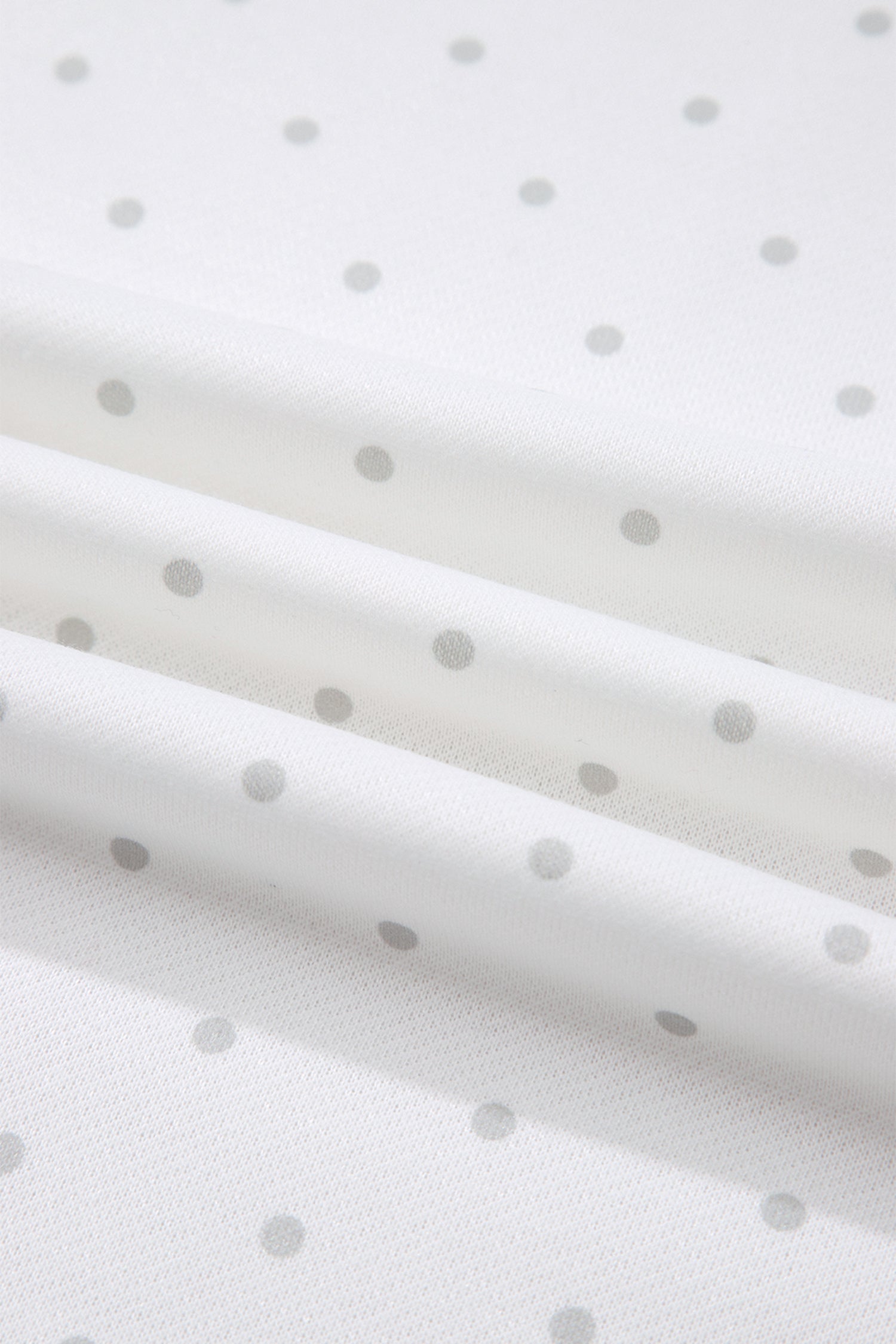 Grey polka dot print fabric close-up on white set