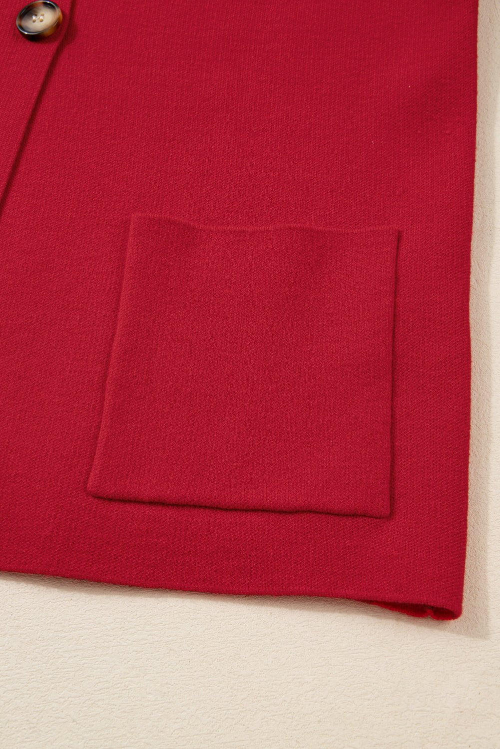 Red fabric with a pocket on a beige background