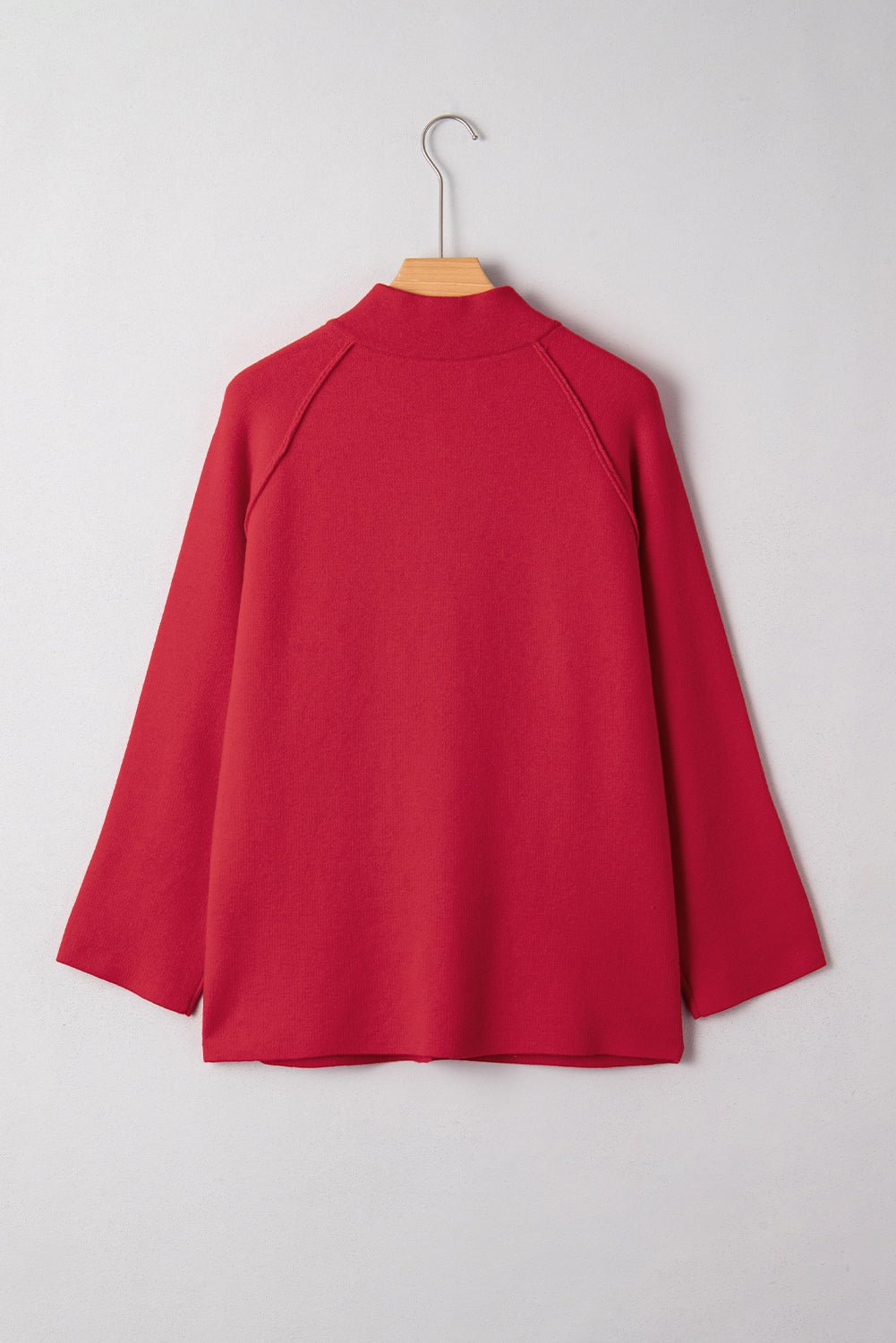 Red jacket on a hanger against a white background