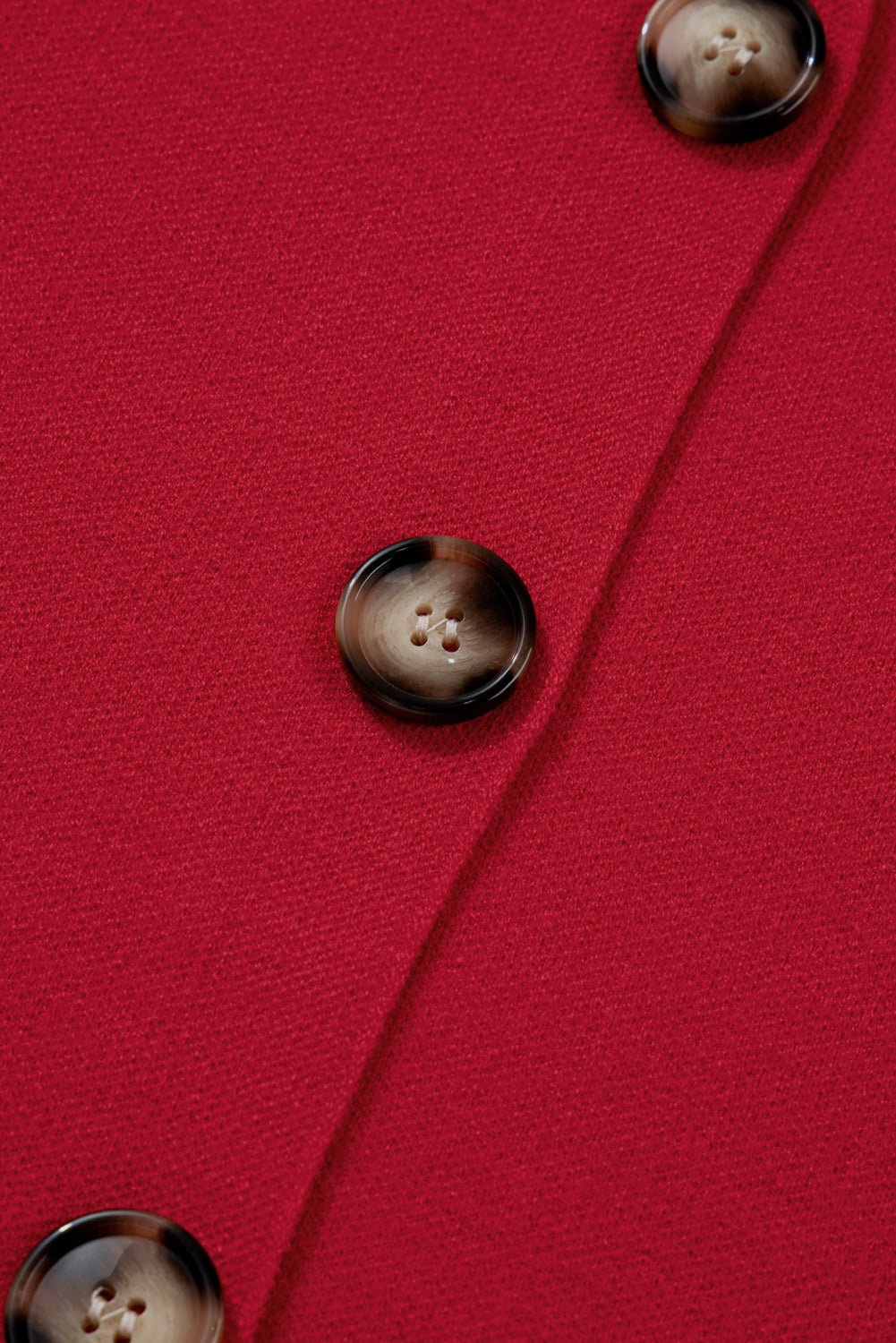 Close-up of a red fabric with brown buttons