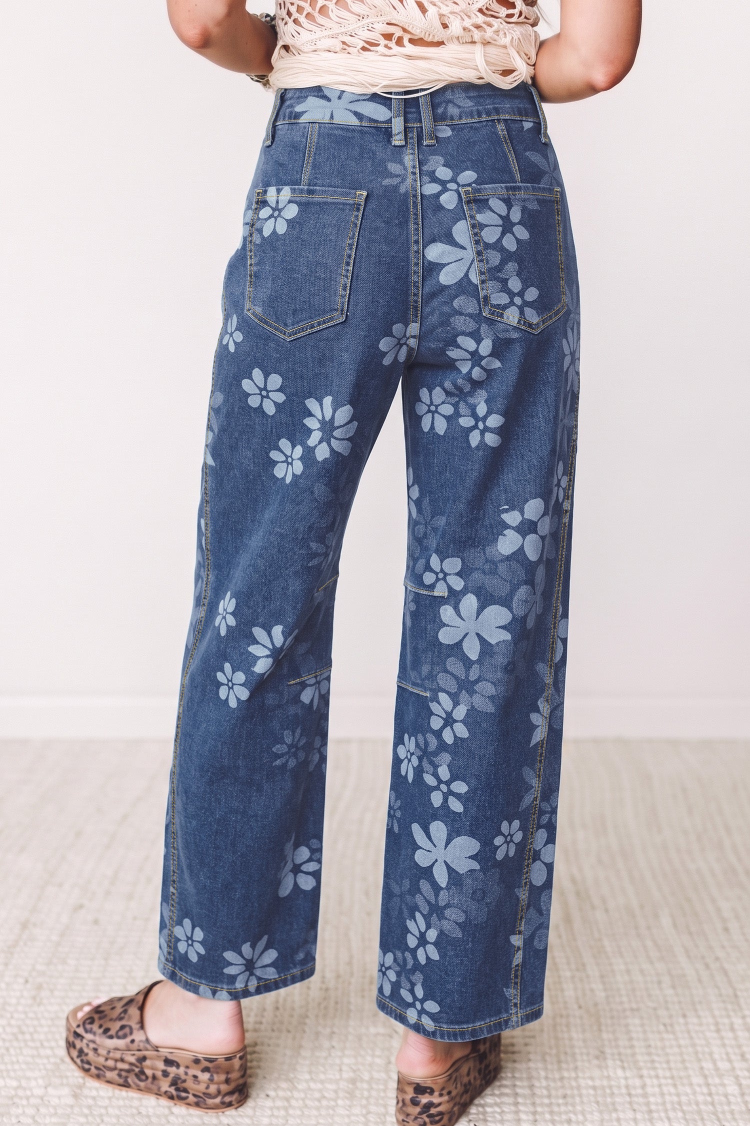 Women's blue floral print wide leg jeans with back patch pockets, back view