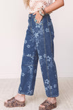 Blue floral denim barrel leg jeans with seamed knee, side view
