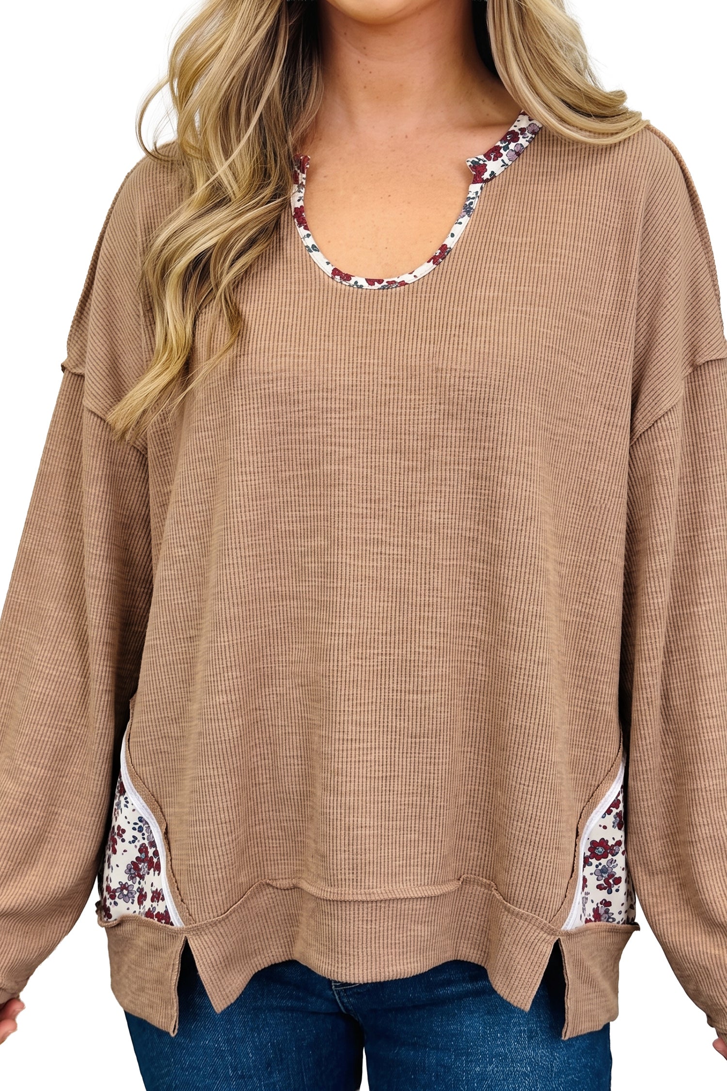 Close-up of beige ribbed tunic with floral U neckline and side slits