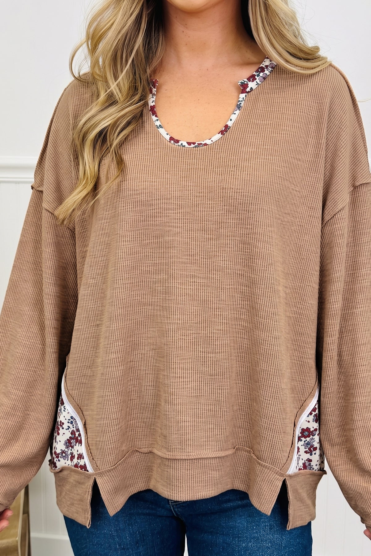 Women's beige ribbed tunic top with floral U neck and side trim, front view