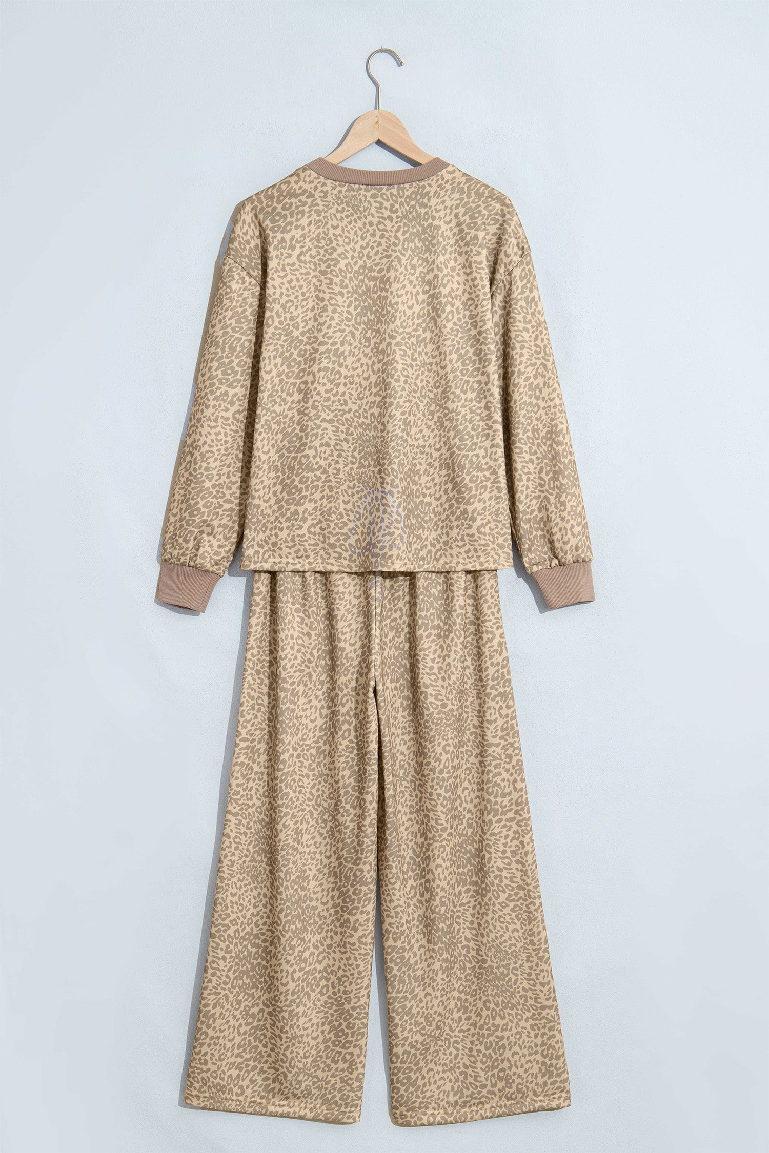 Khaki leopard print top and pants set on a hanger, back view