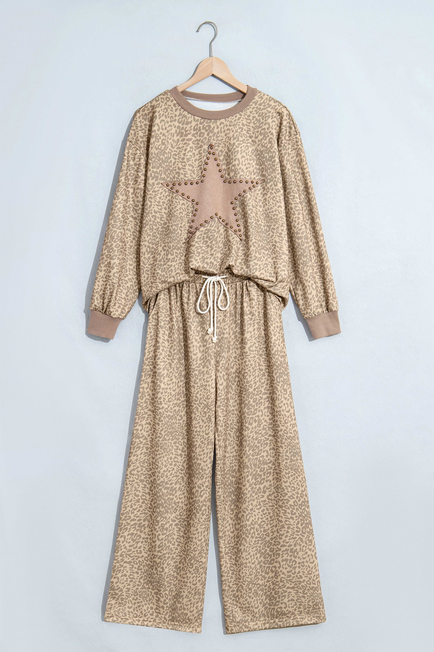 Khaki leopard star print top and pants set on a hanger, front view