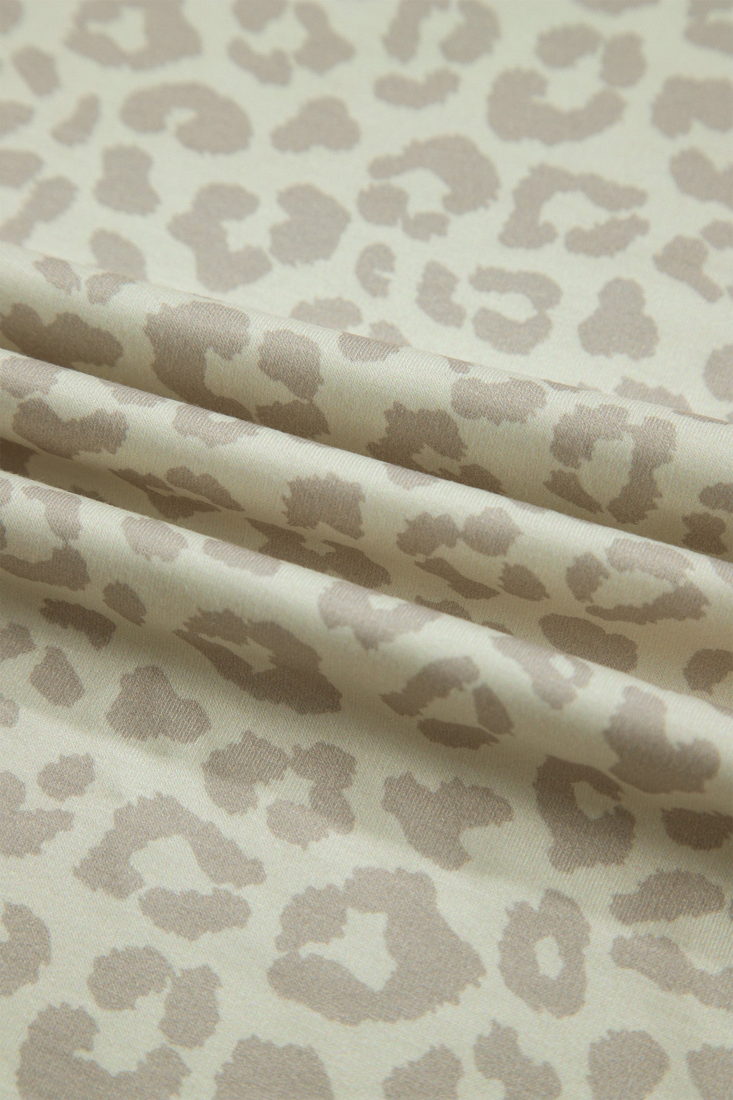 Apricot leopard print fabric texture close-up