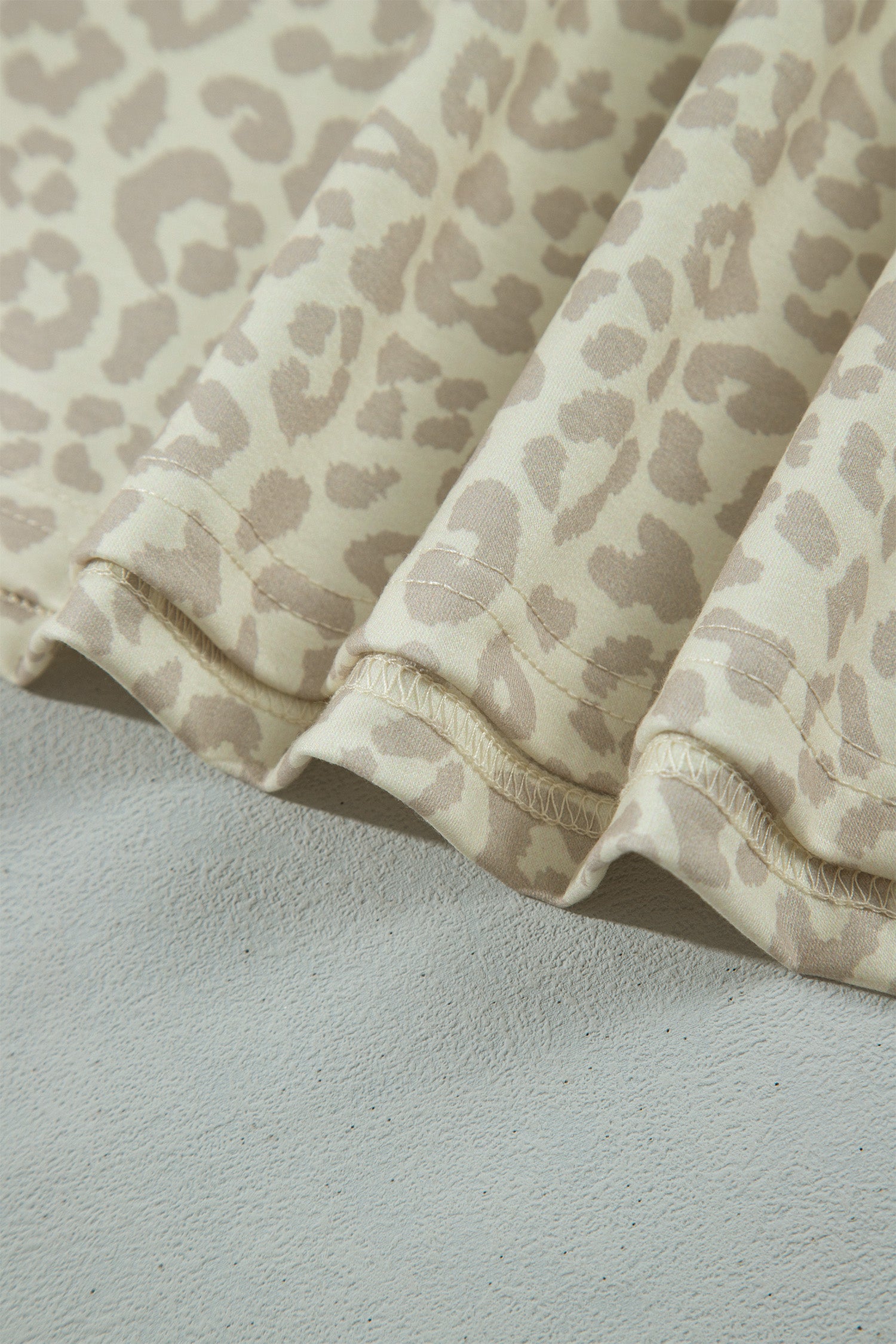 Close-up of apricot leopard print stretch fabric