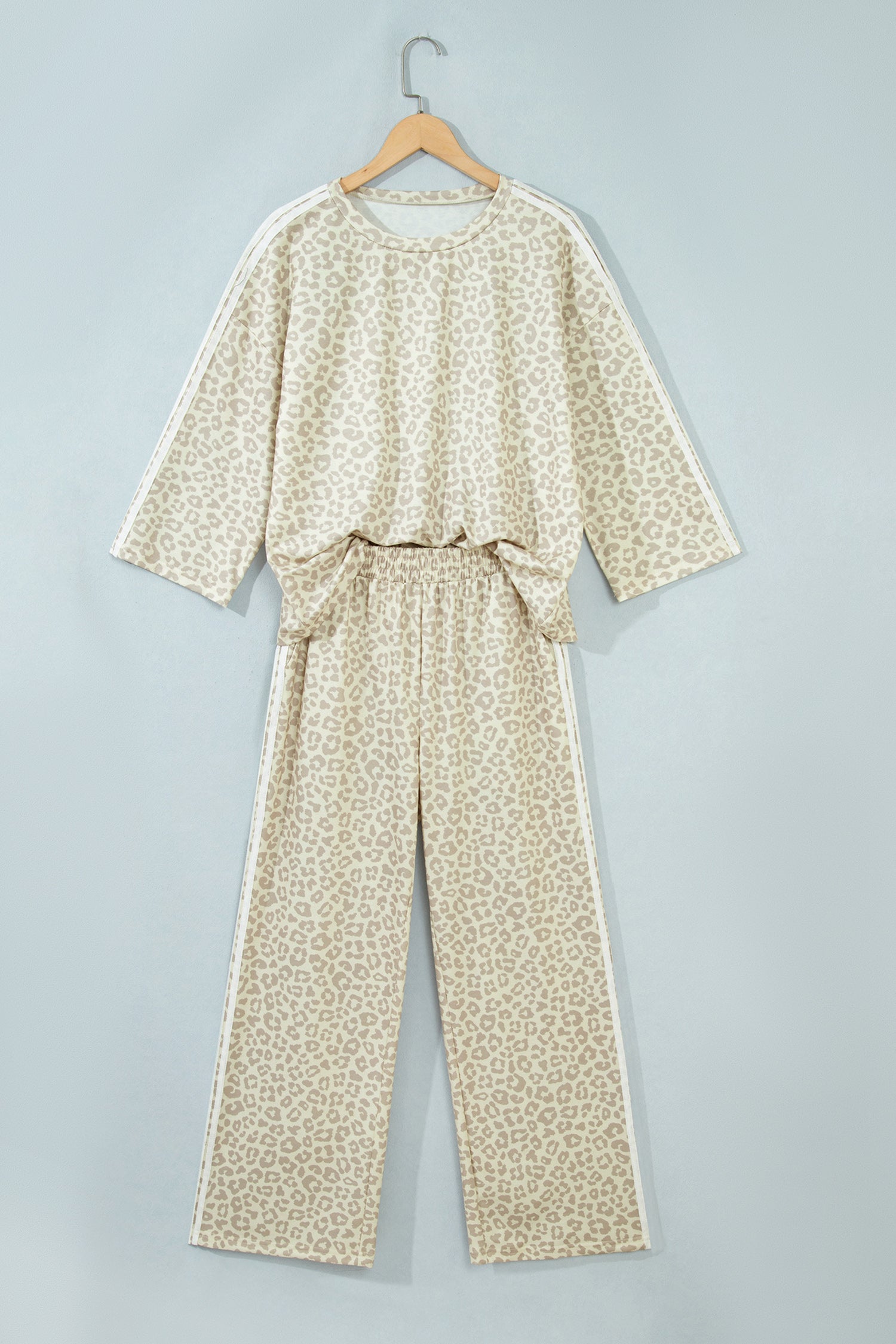 Apricot leopard varsity stripe top and pants set on a hanger, front view