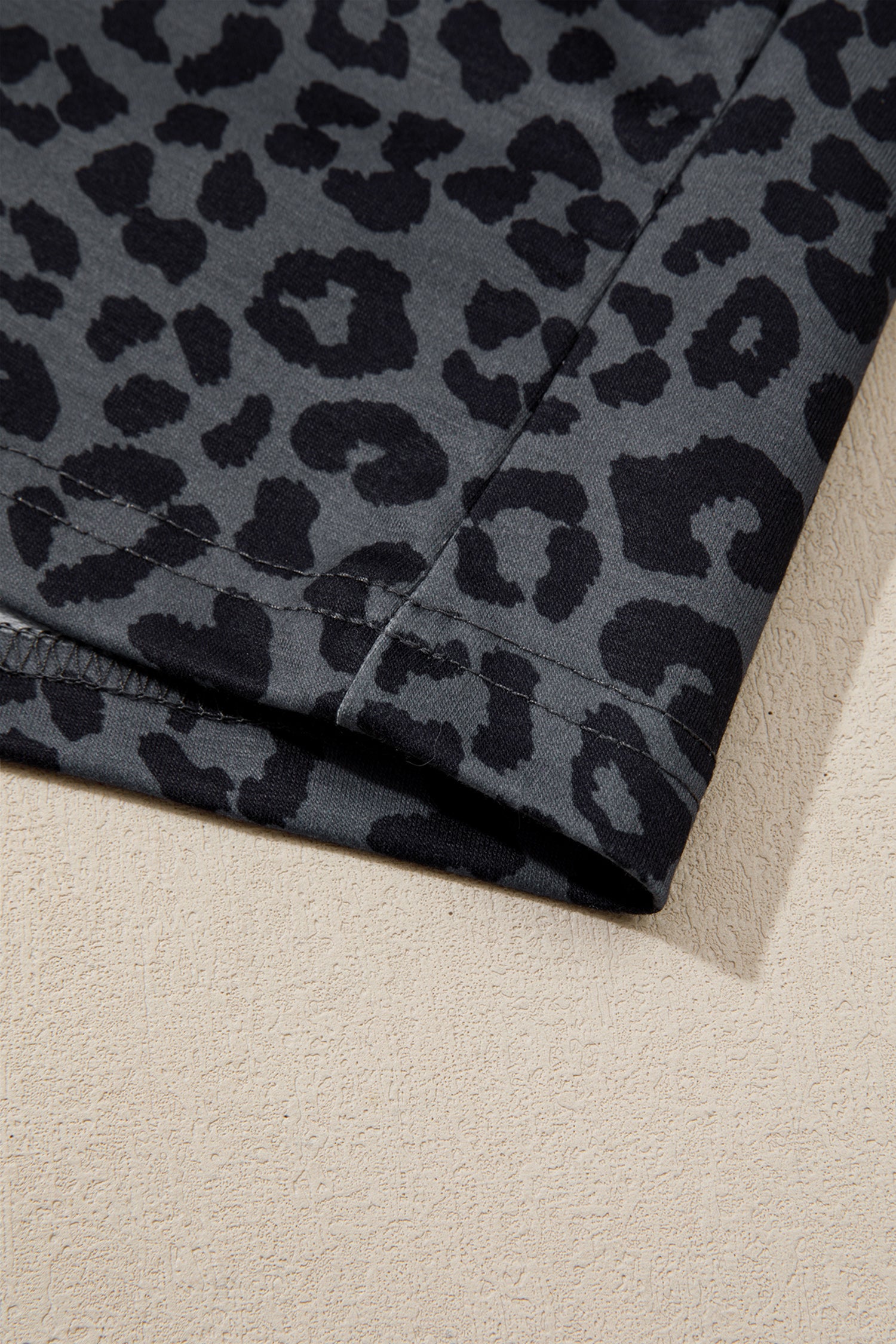 Close-up of gray leopard print stretch fabric
