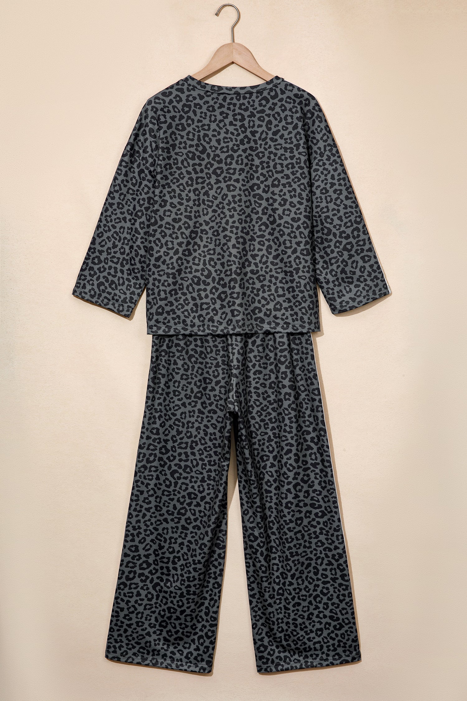 Gray leopard print top and pants set on a hanger, back view
