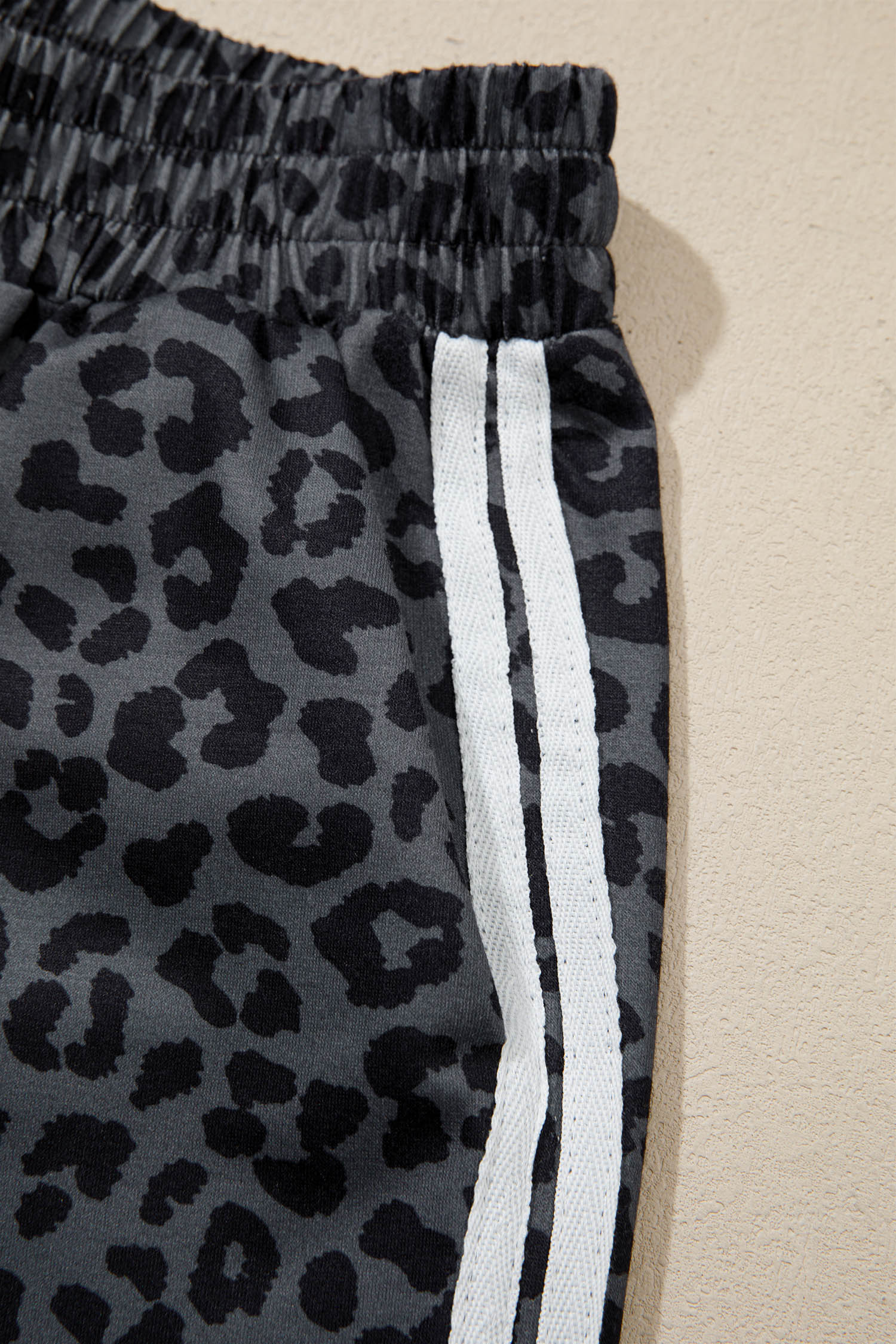 Gray leopard pants with white varsity side stripes