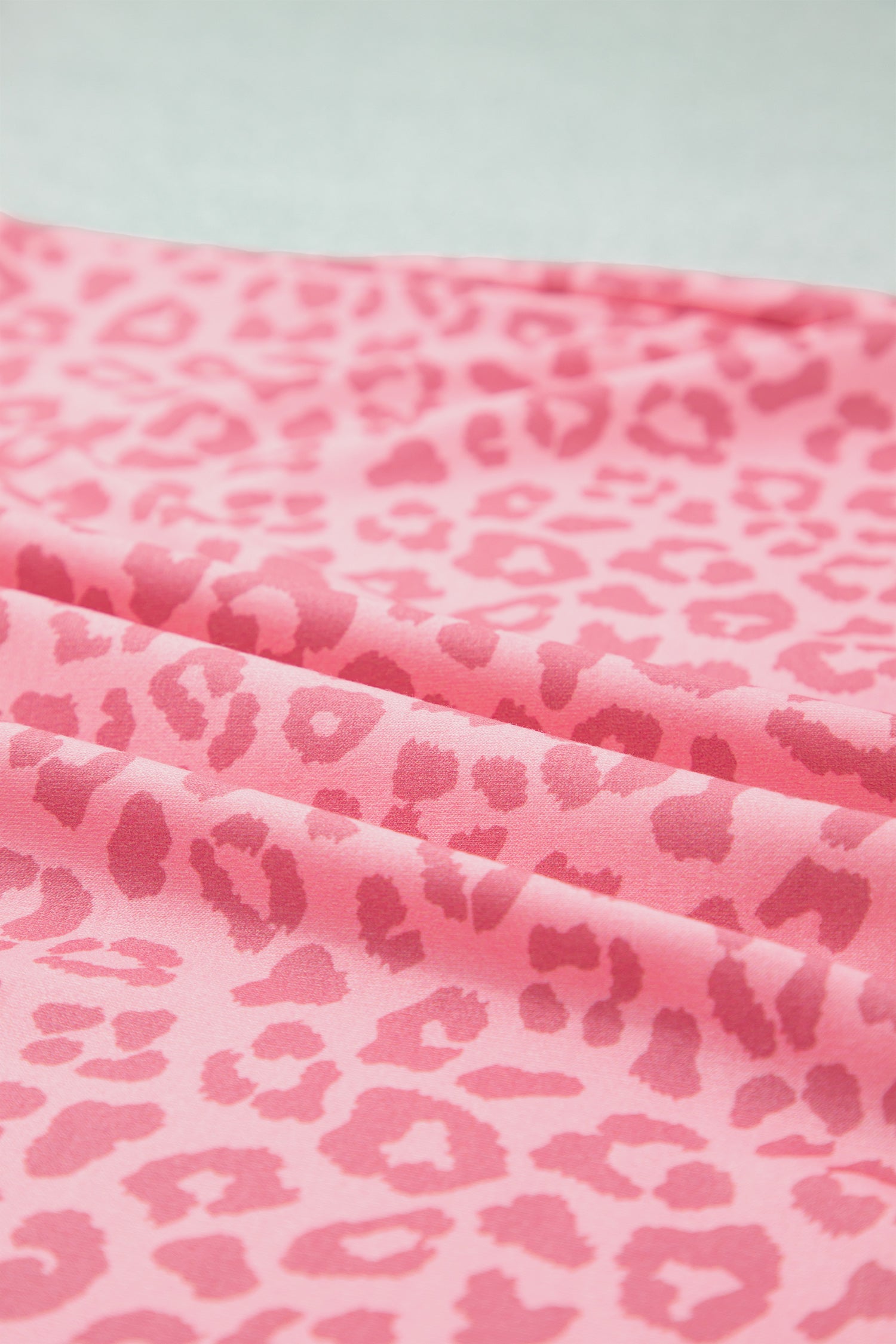 Close-up of pink leopard print stretch fabric