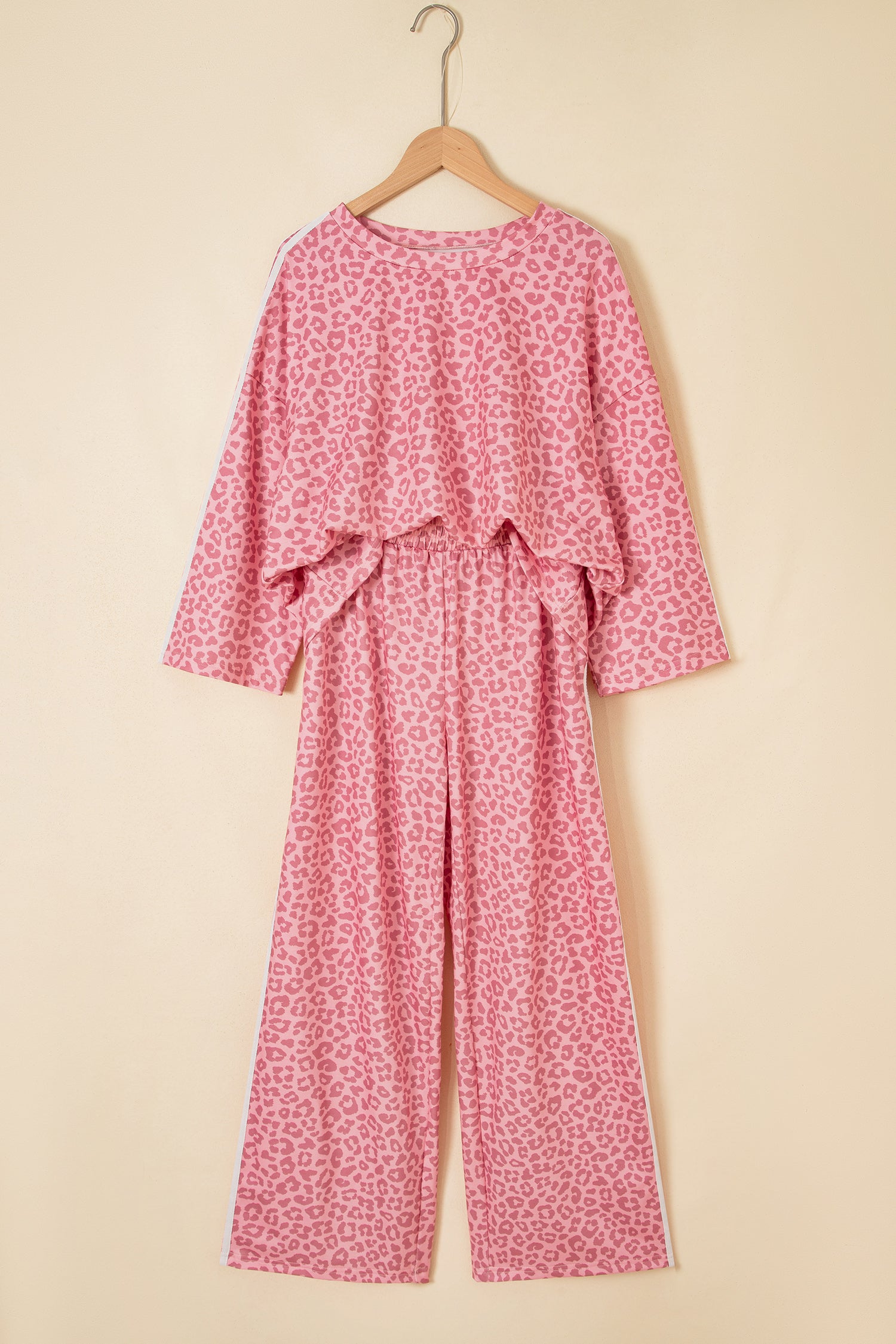 Pink leopard varsity stripe top and pants set on a hanger, front view