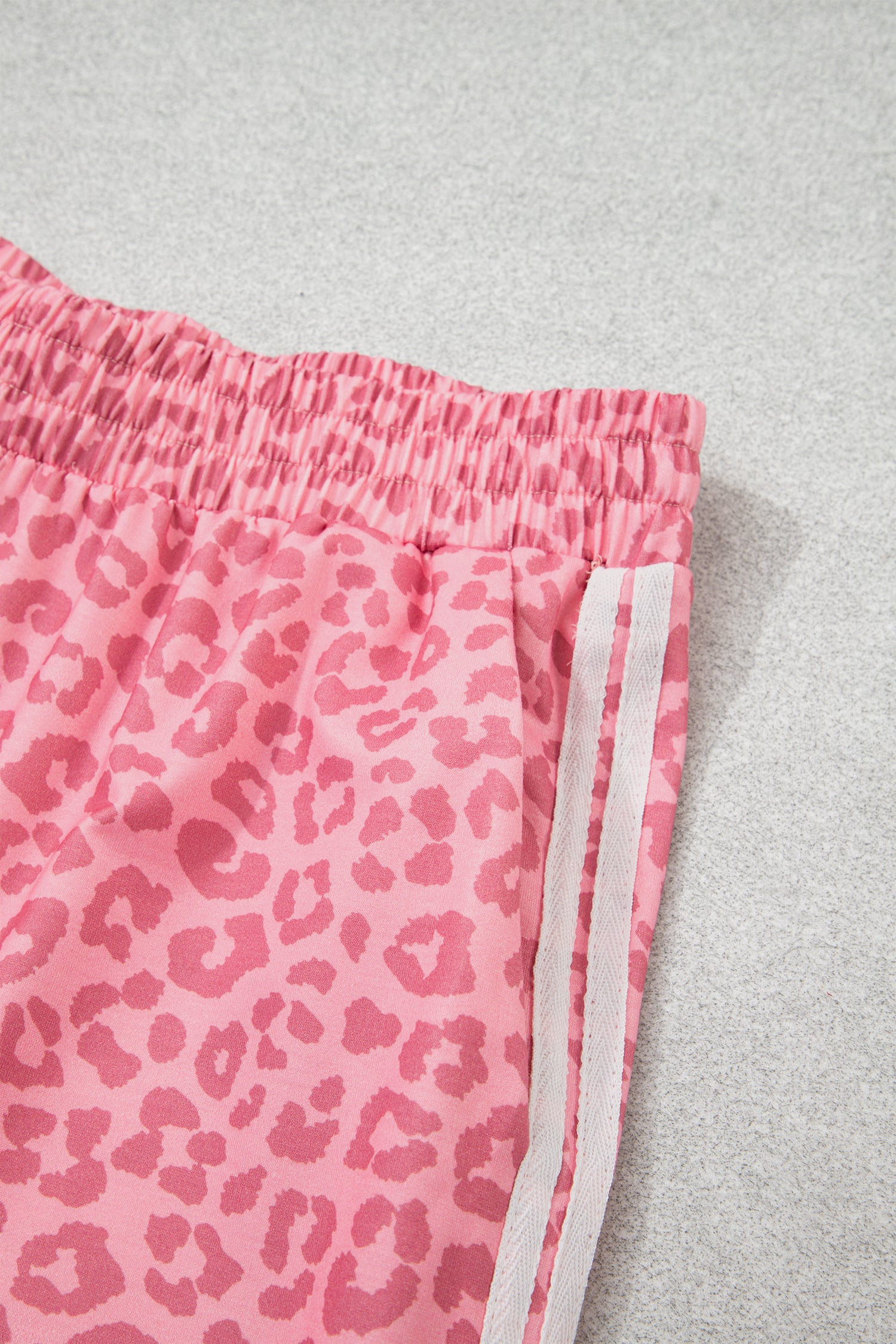 Pink leopard pants with white varsity side stripes