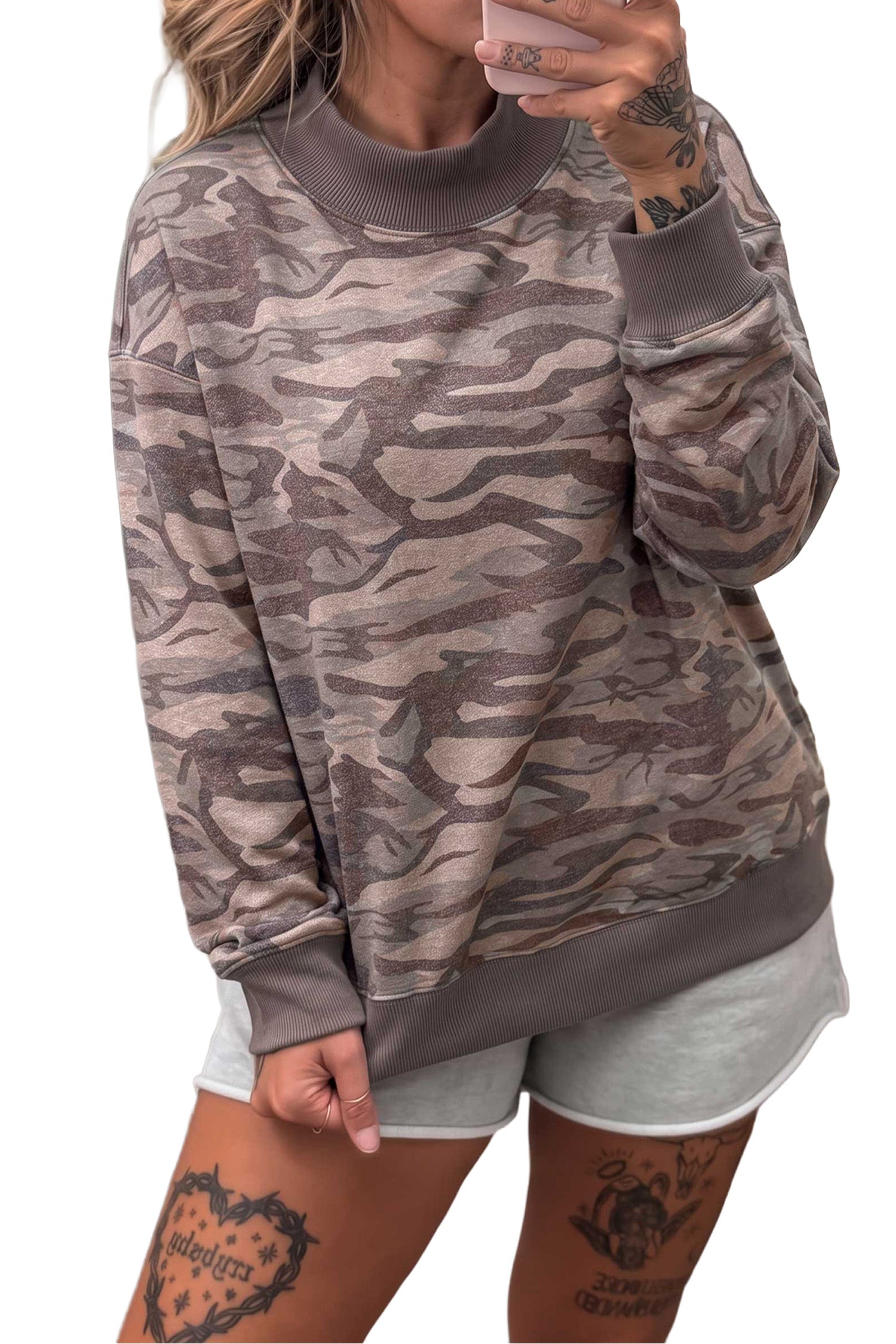 Muted camo mock neck sweatshirt with grey shorts, mirror selfie front view