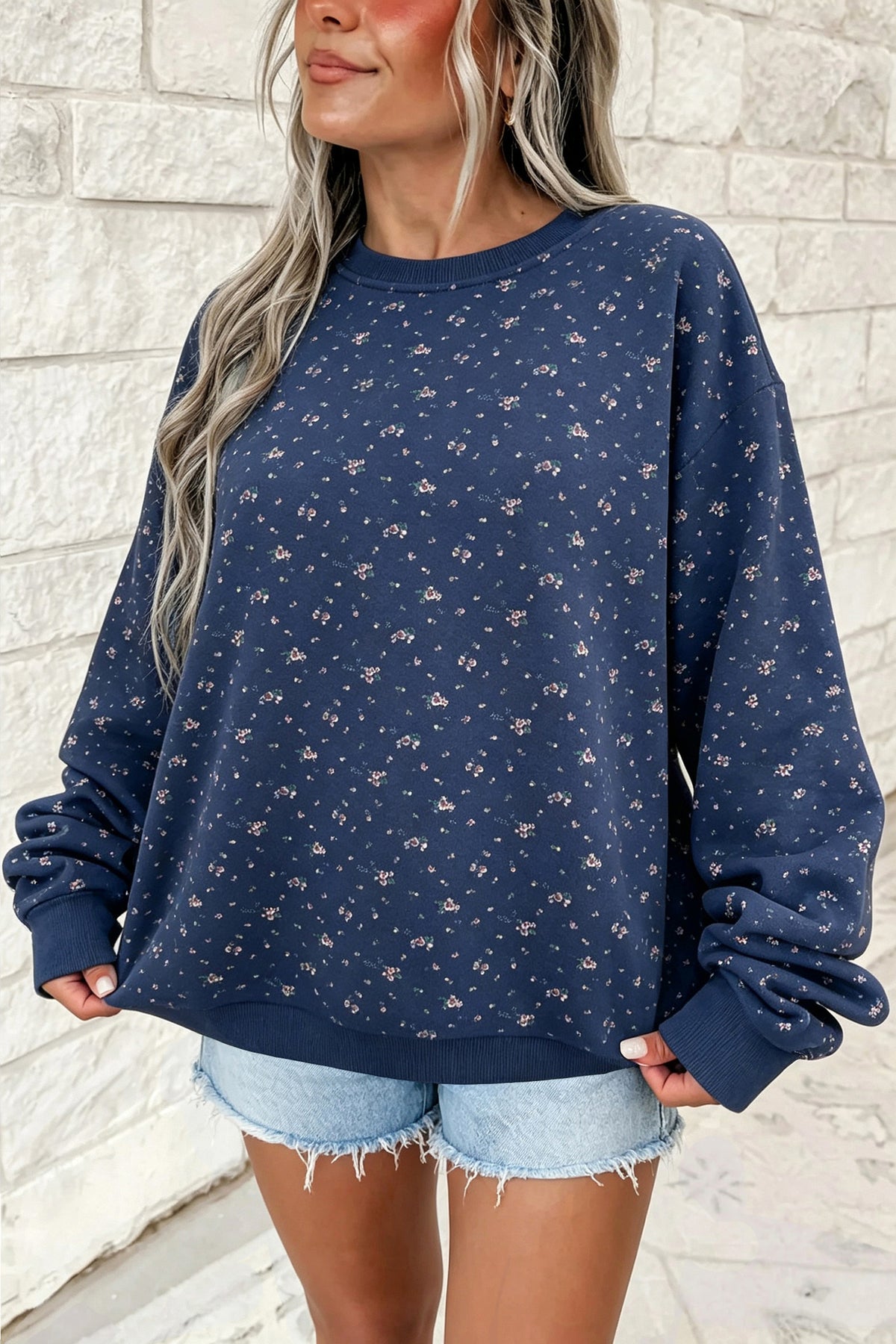 Women's navy floral print oversized sweatshirt, front view with denim shorts