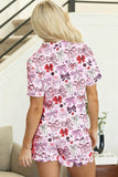 Person wearing a pink pajama set with bow pattern in a home setting