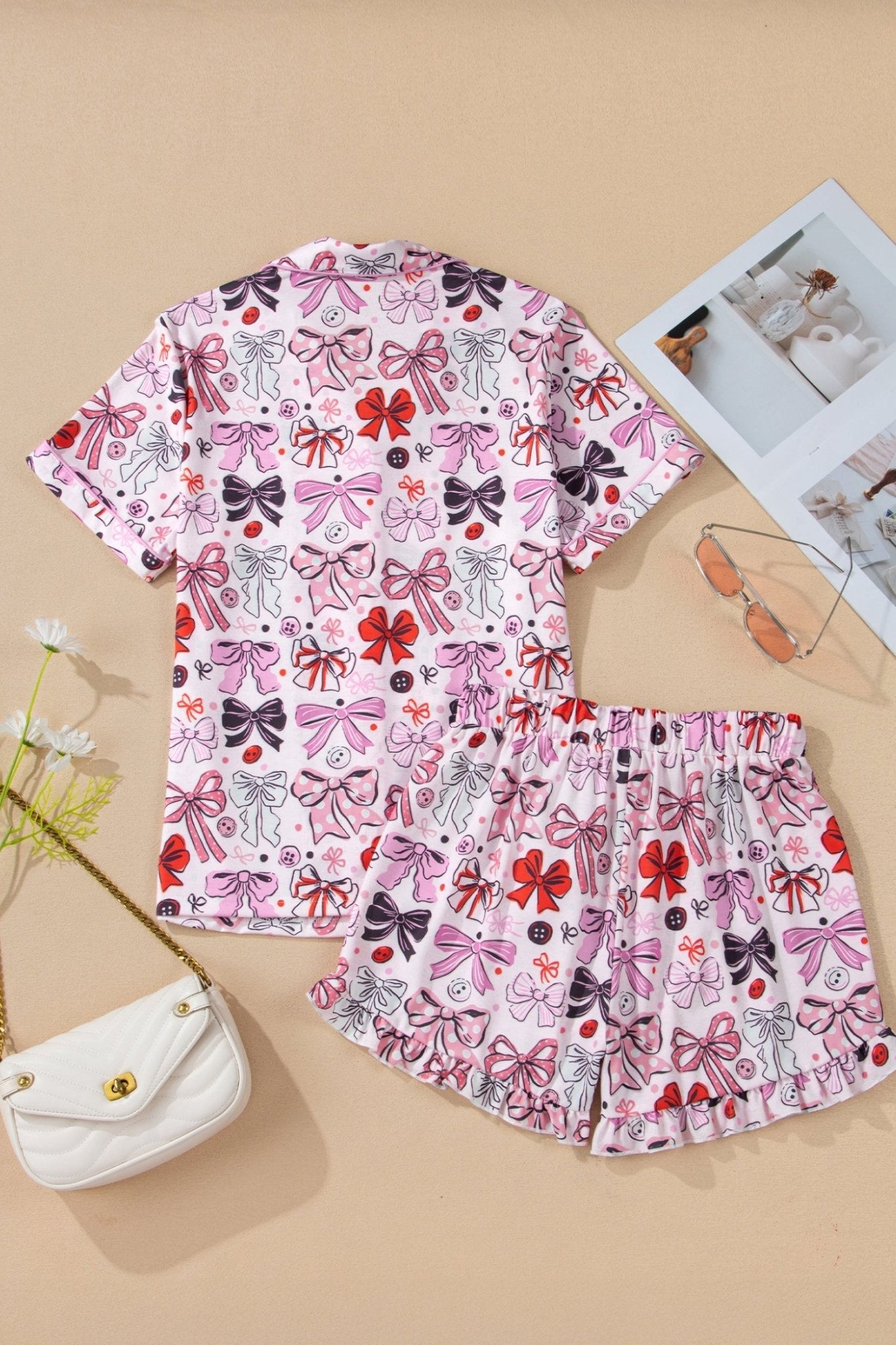 Children's outfit with bow pattern on a beige background