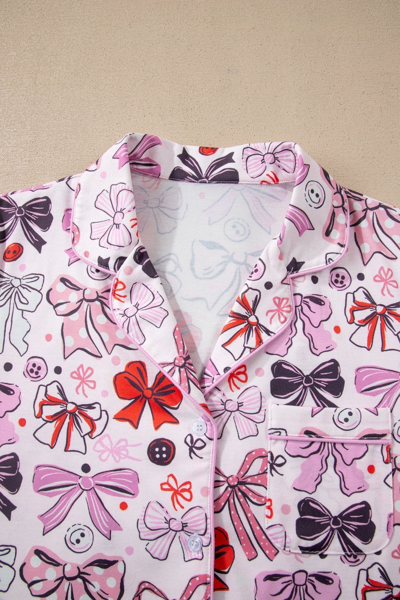 Shirt with a colorful bow pattern on a beige background
