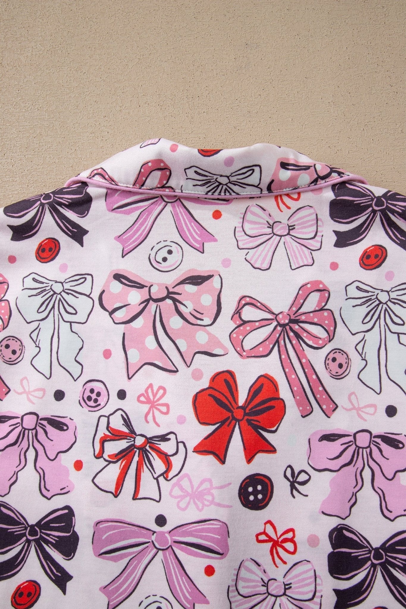 Fabric with colorful bow pattern on a beige background