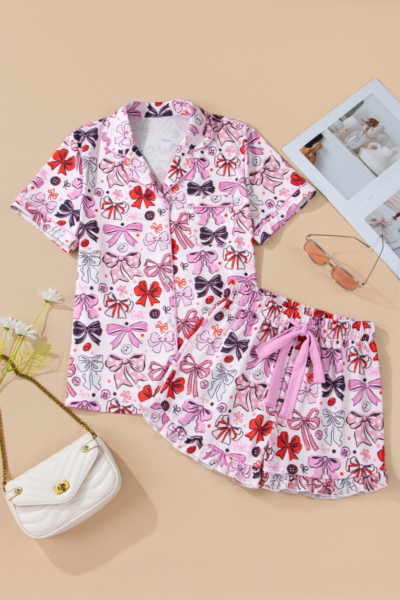Children's outfit with pink bow pattern on a beige background