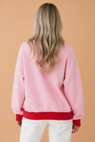 Women's plus size pink sweatshirt with red ribbed trim, back view