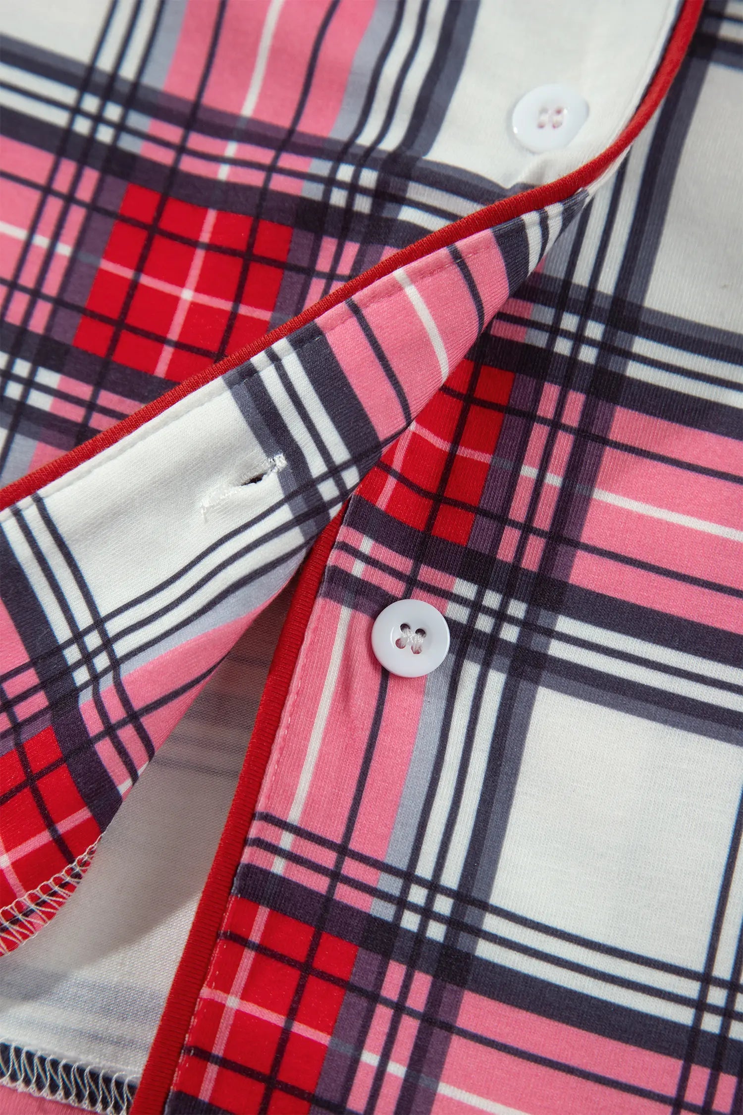 Red plaid pajama top with red piping and white buttons