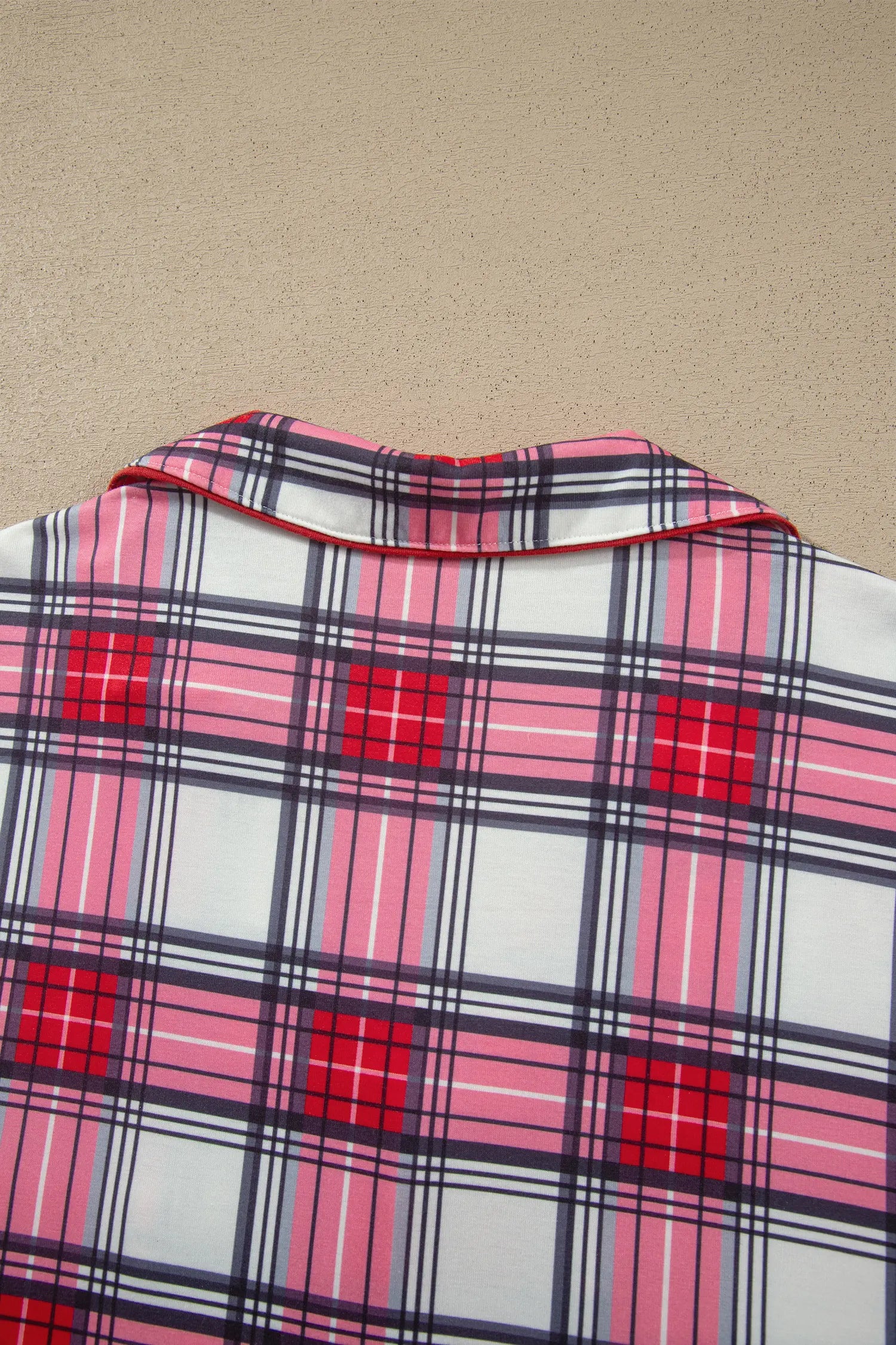 Close-up of red plaid pajama top notched collar