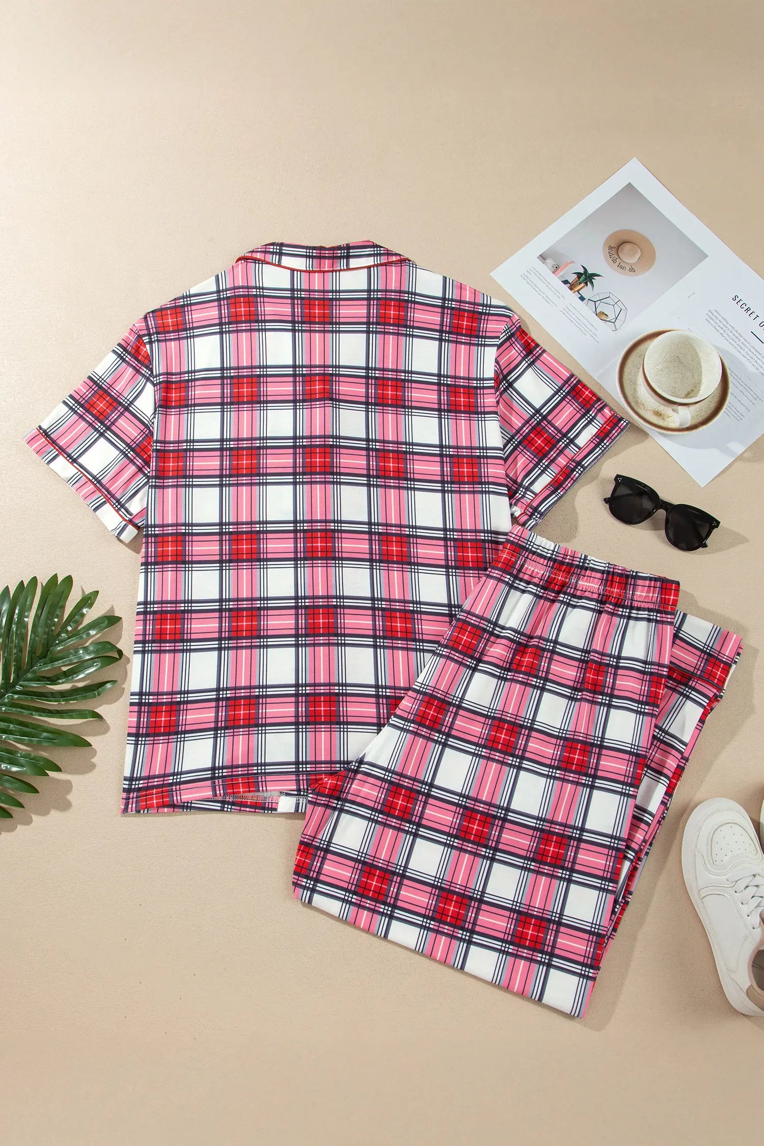Red plaid button down pajama set with folded pants, flat lay