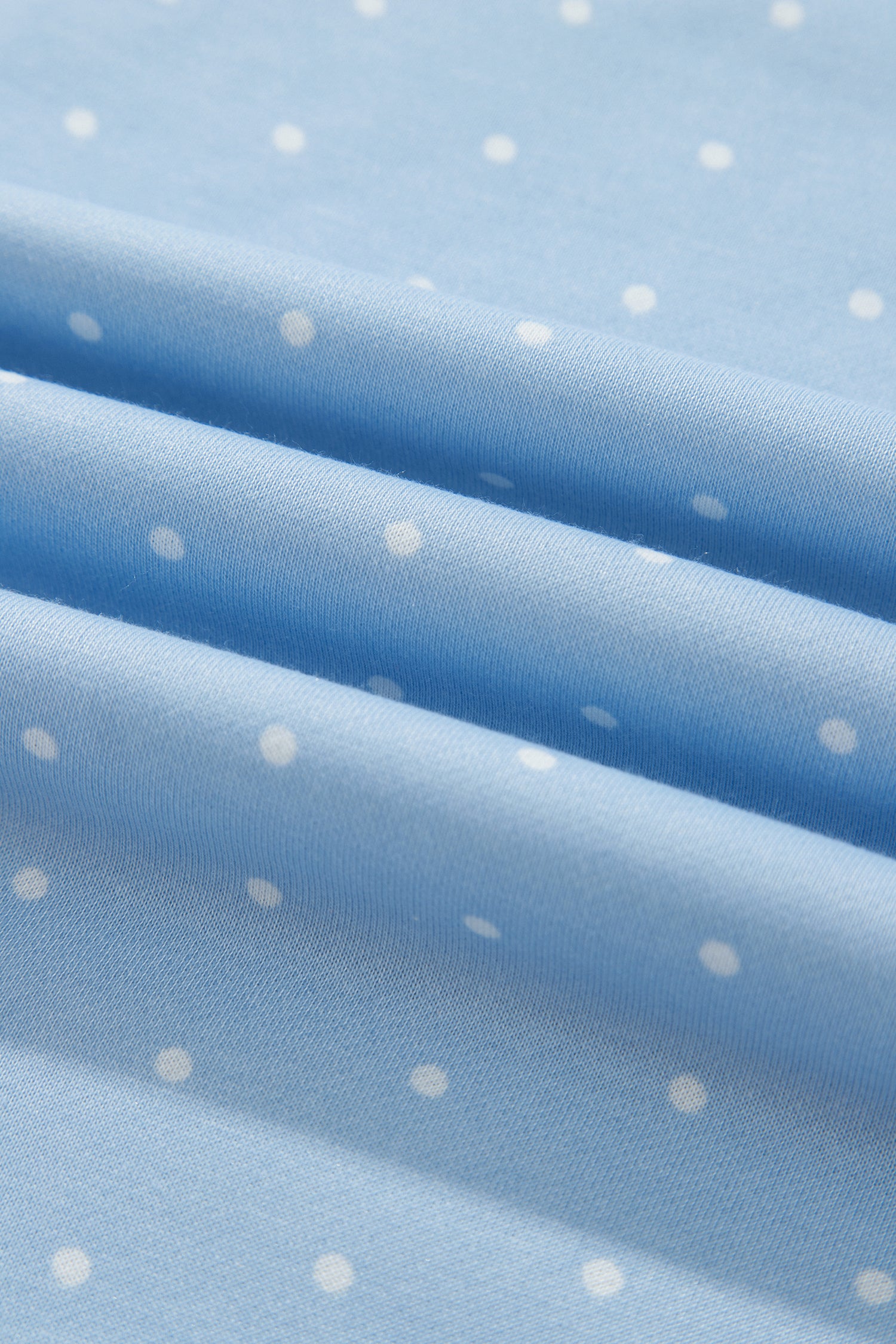 Close-up of sky blue polka dot fleece fabric