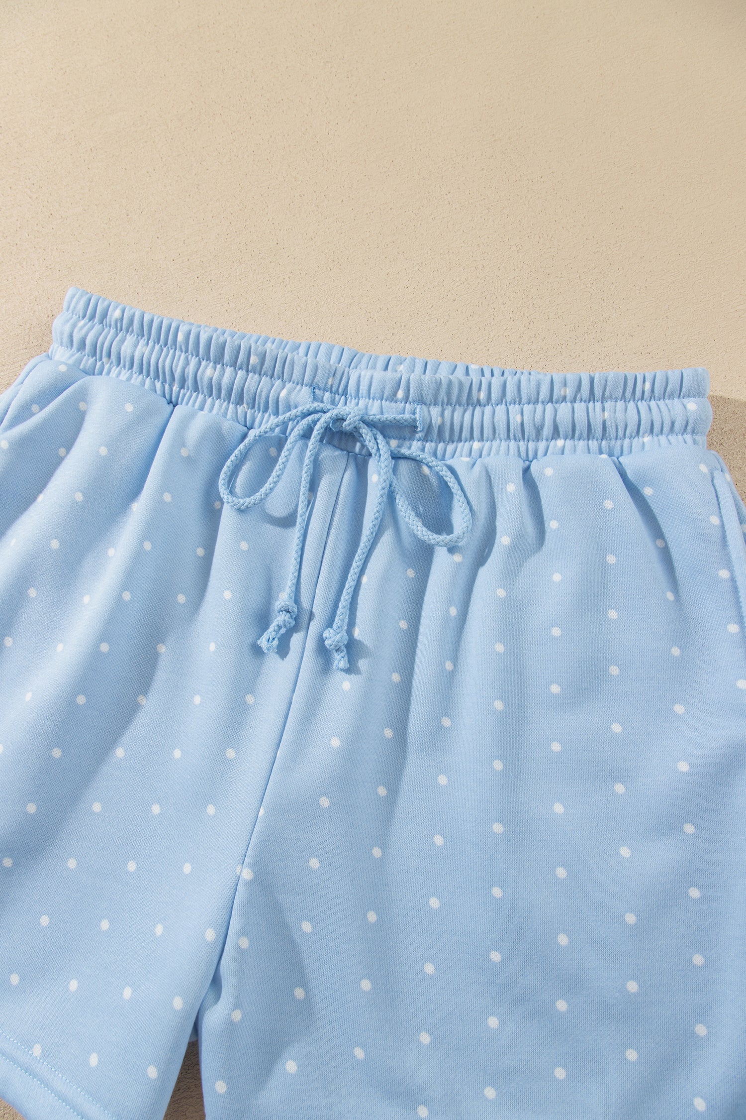 Sky blue polka dot drawstring shorts, flat lay
