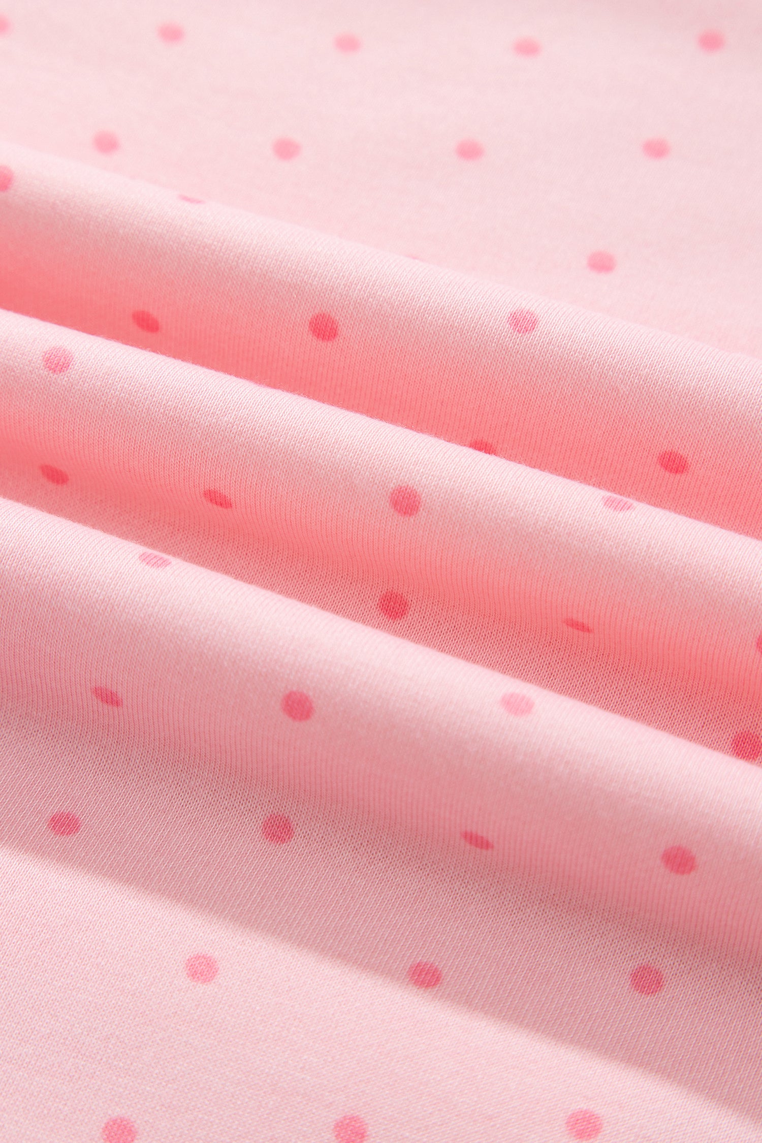 Close-up of pink polka dot fleece fabric