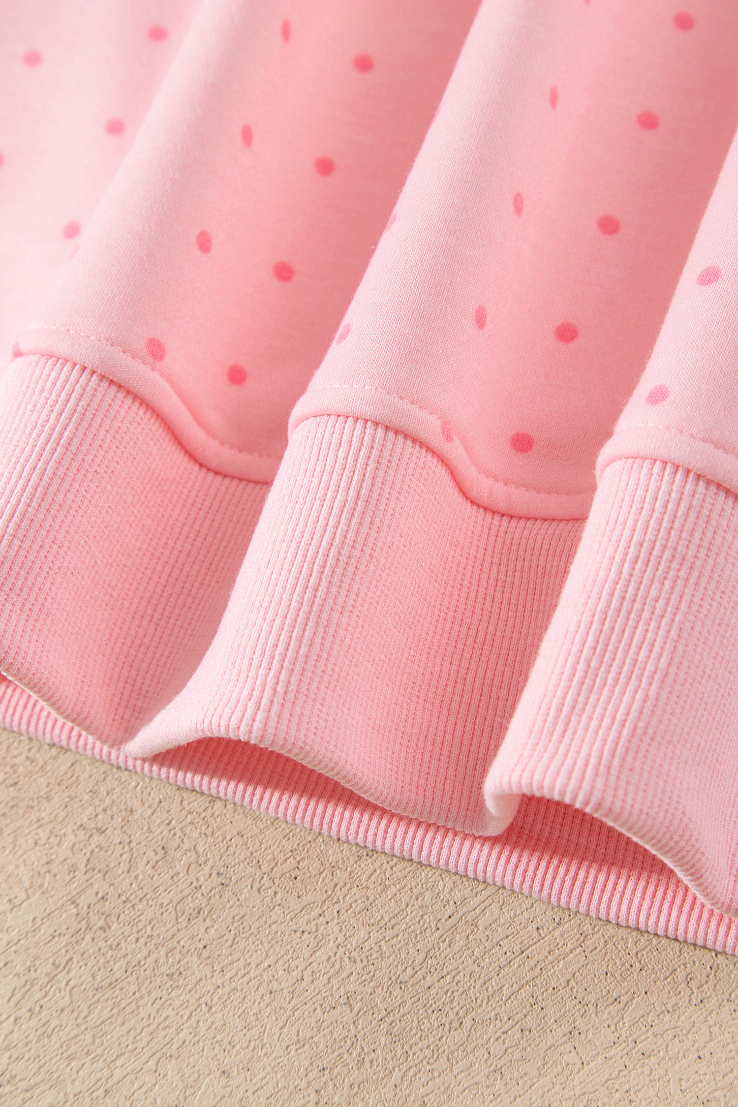 Pink polka dot hoodie hem with side slit