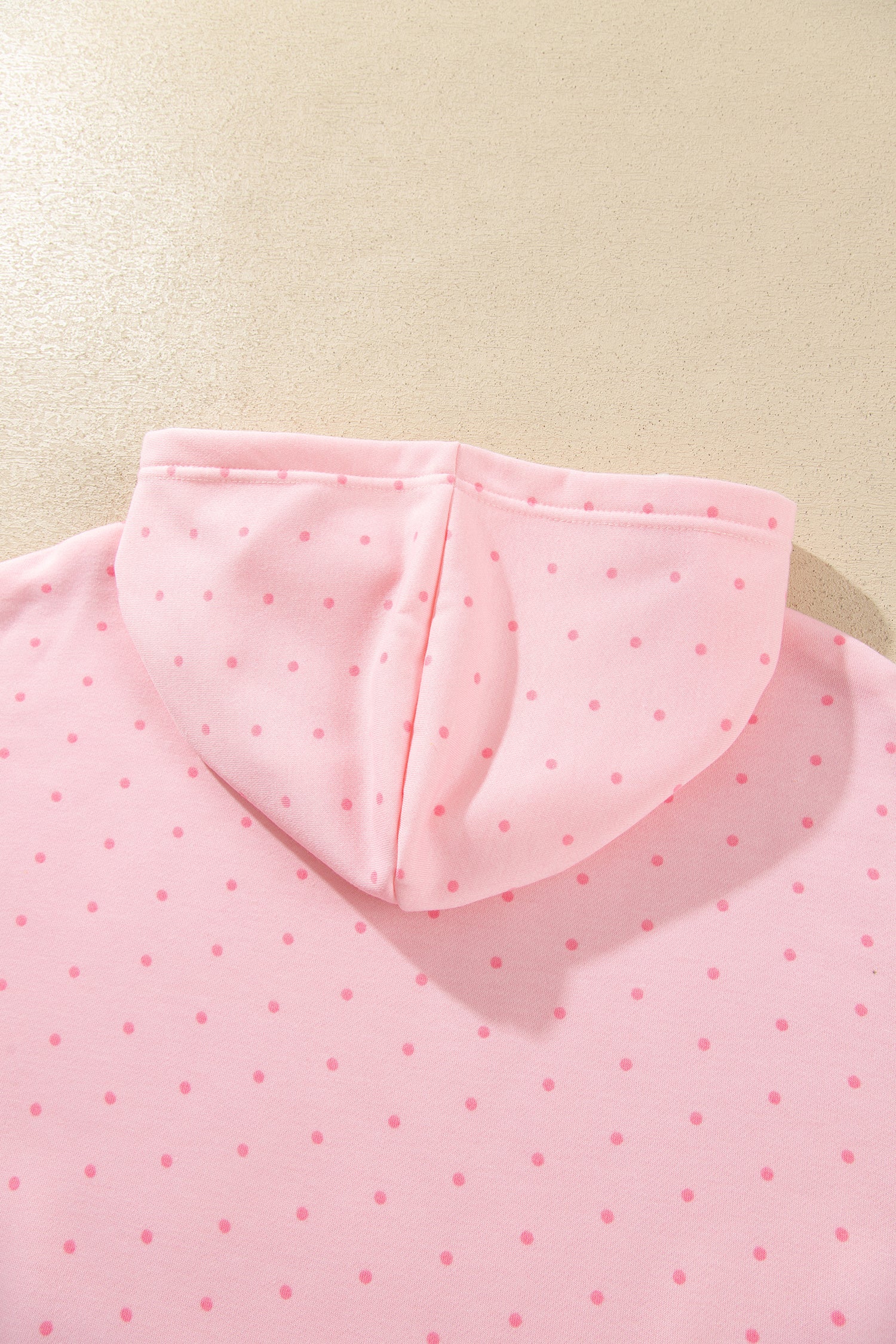 Pink polka dot hoodie hood, back view