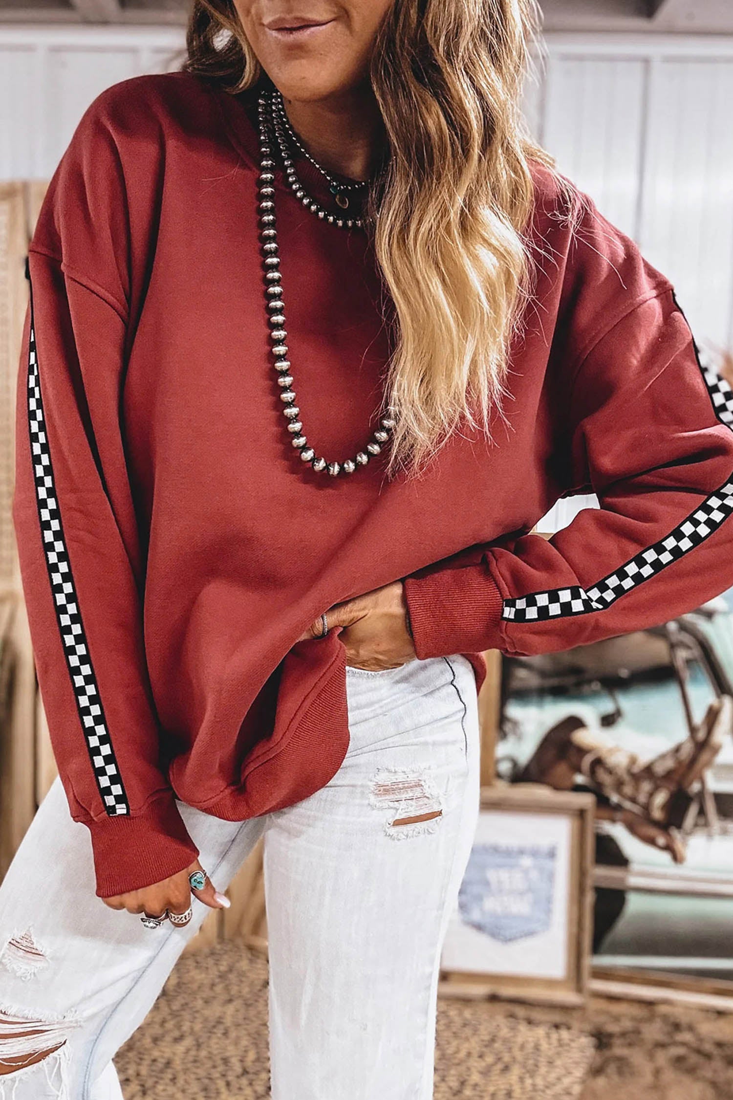 Women's mineral red checkered trim oversized sweatshirt with white jeans, front view