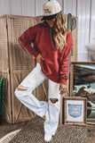 Women's red checkered trim sweatshirt with distressed white jeans, full view