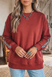 Women's mineral red crewneck sweatshirt with light blue jeans, front view