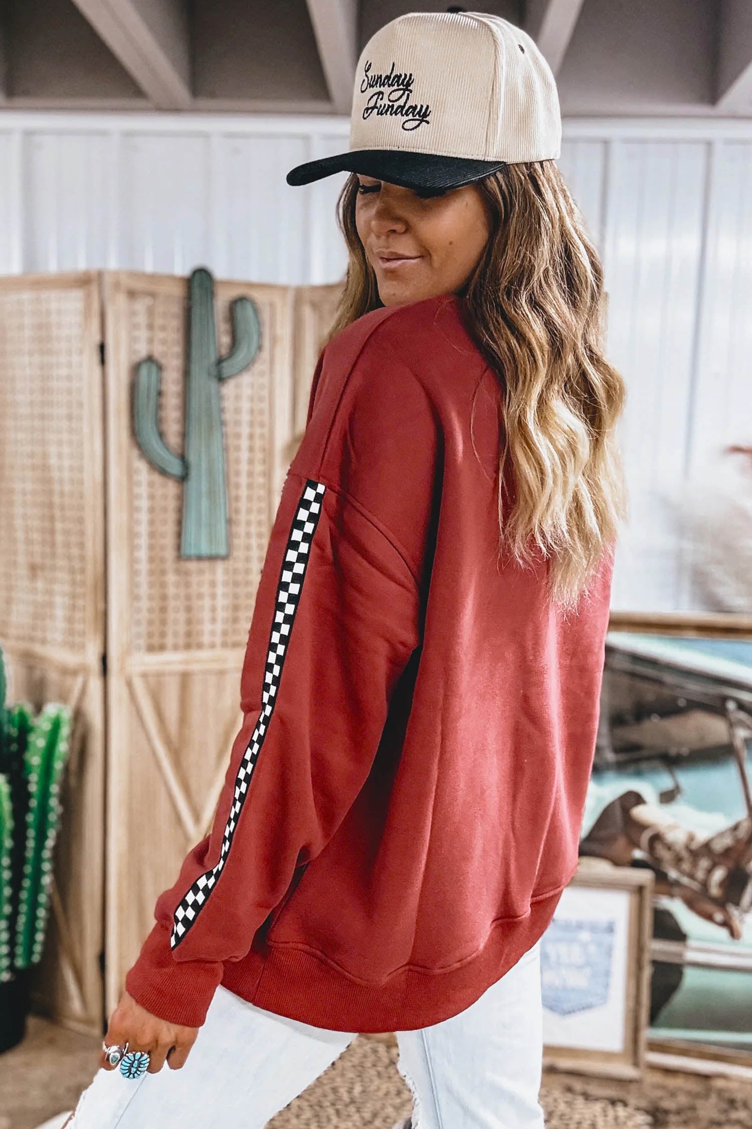 Red checkered sleeve sweatshirt with trucker cap, side back view