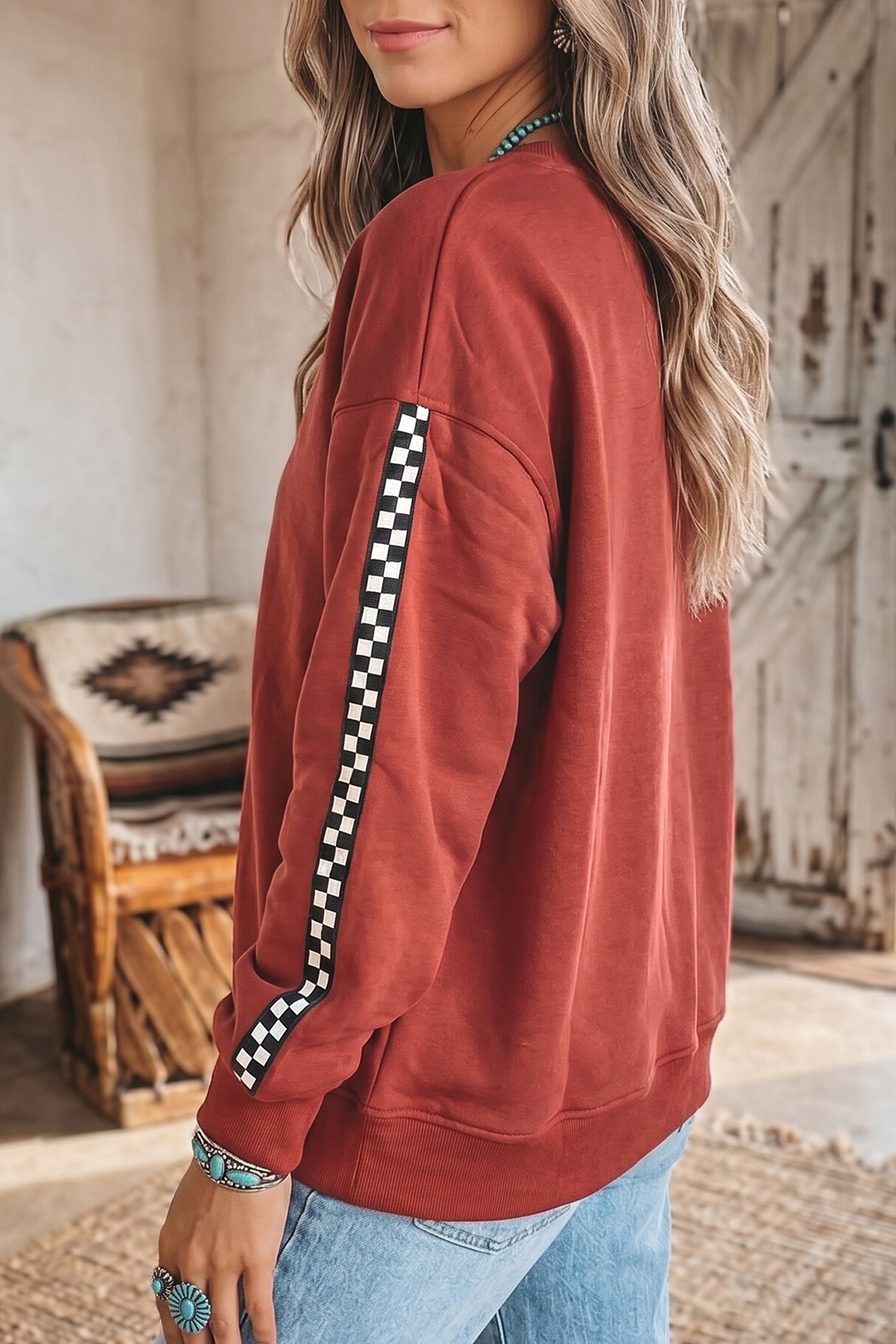 Mineral red sweatshirt with black and white checkered sleeve, side view