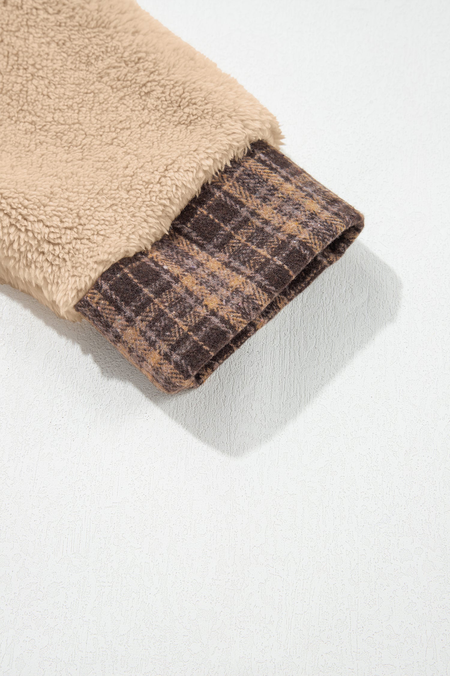 Beige sherpa sleeve with brown plaid cuff