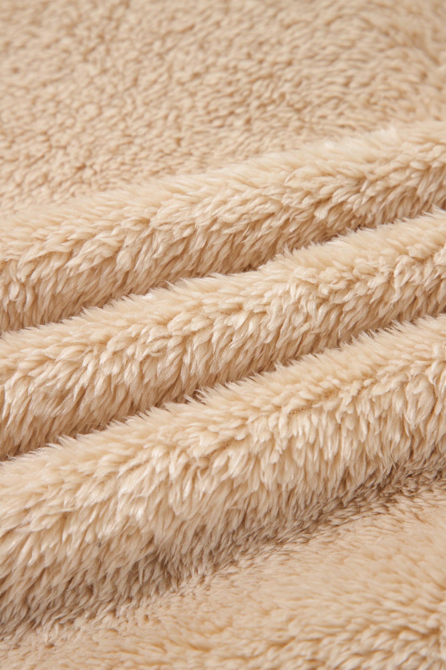 Close-up of soft beige sherpa fleece fabric