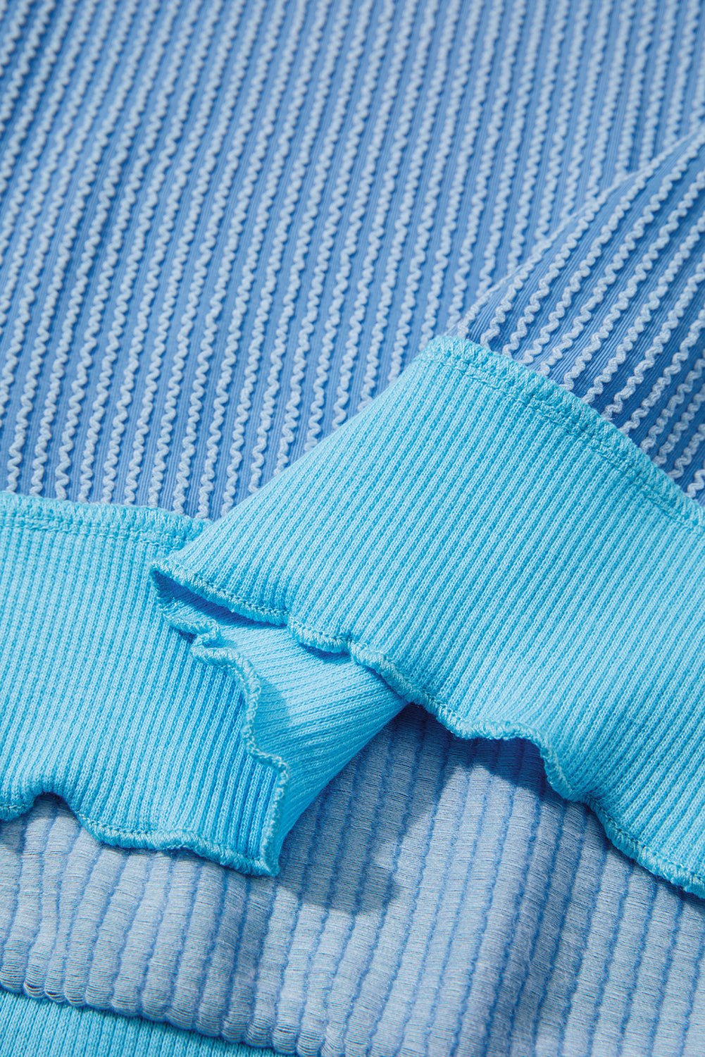 Close-up of blue textured fabric with a frayed edge